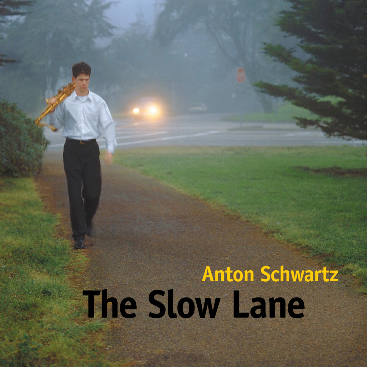 Man with saxophone walking on a road, foggy background, album cover.