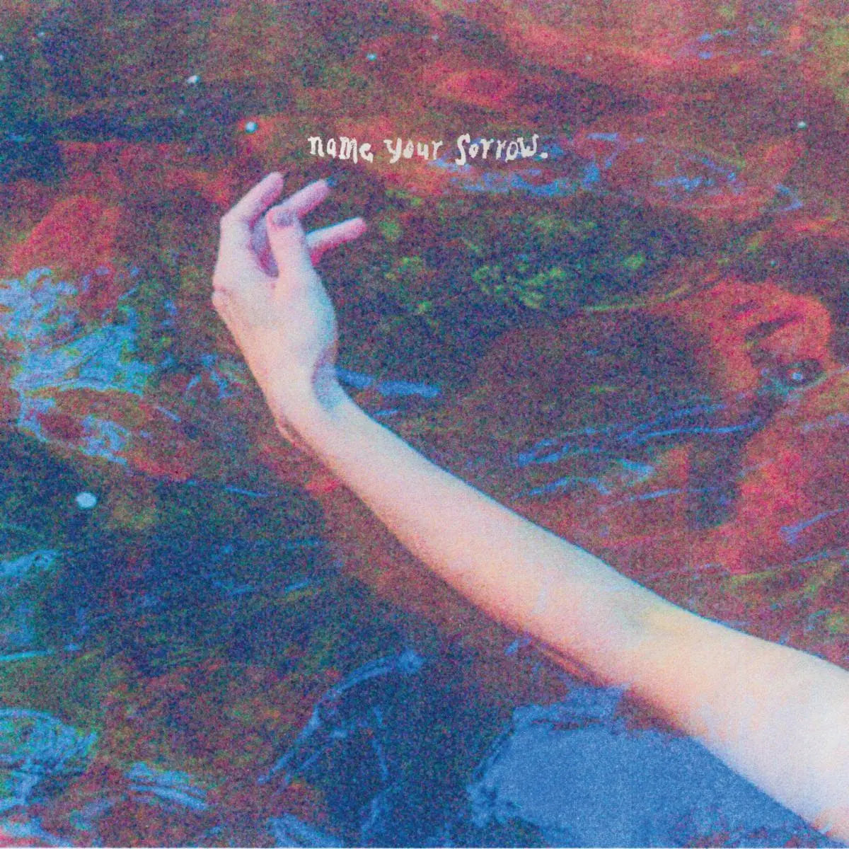 Album cover: a hand reaching into a swirling, colorful abstract background.