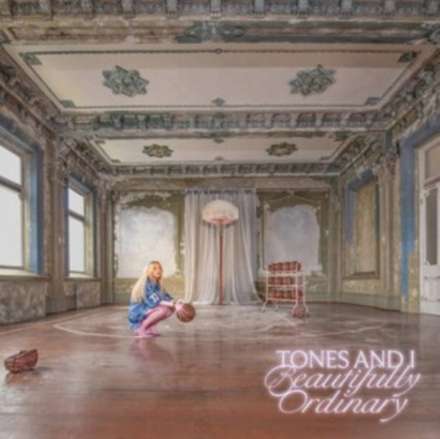 Tones And I album cover: singer in ornate, decaying room with basketballs.