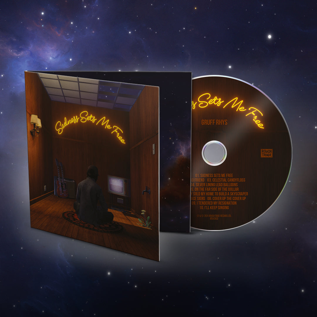 CD cover for Gruff Rhys’ “Sadness Sets Me Free” with a surreal interior scene.