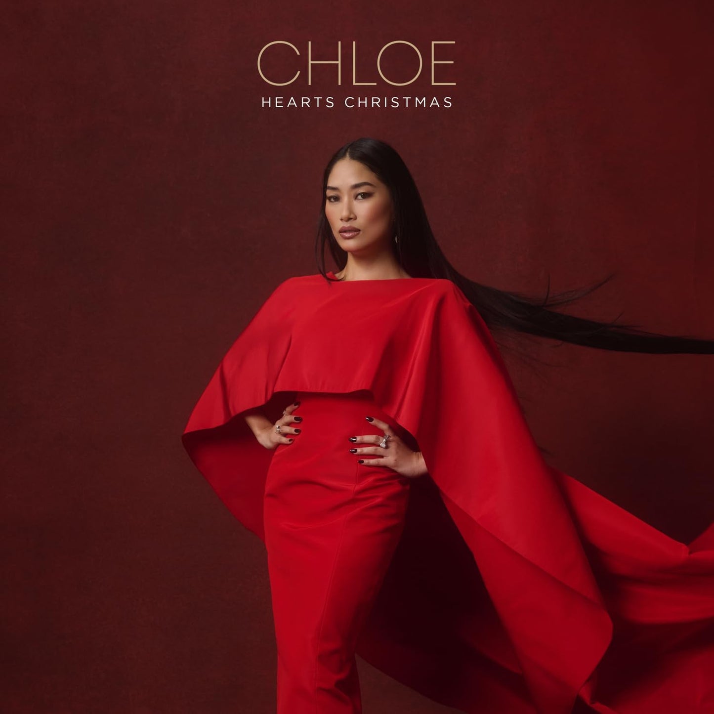 Chloe in a red dress and cape, album cover for "Chloe Hearts Christmas".