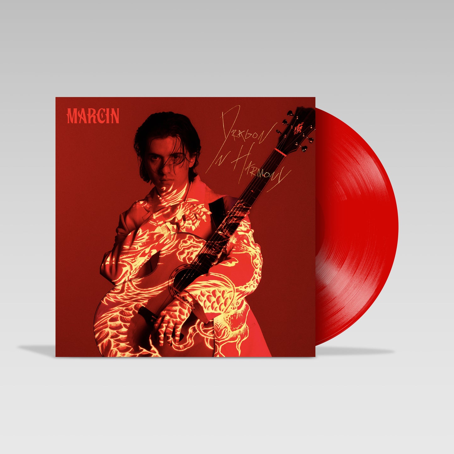 Red vinyl record with portrait of Marcin and a dragon design.