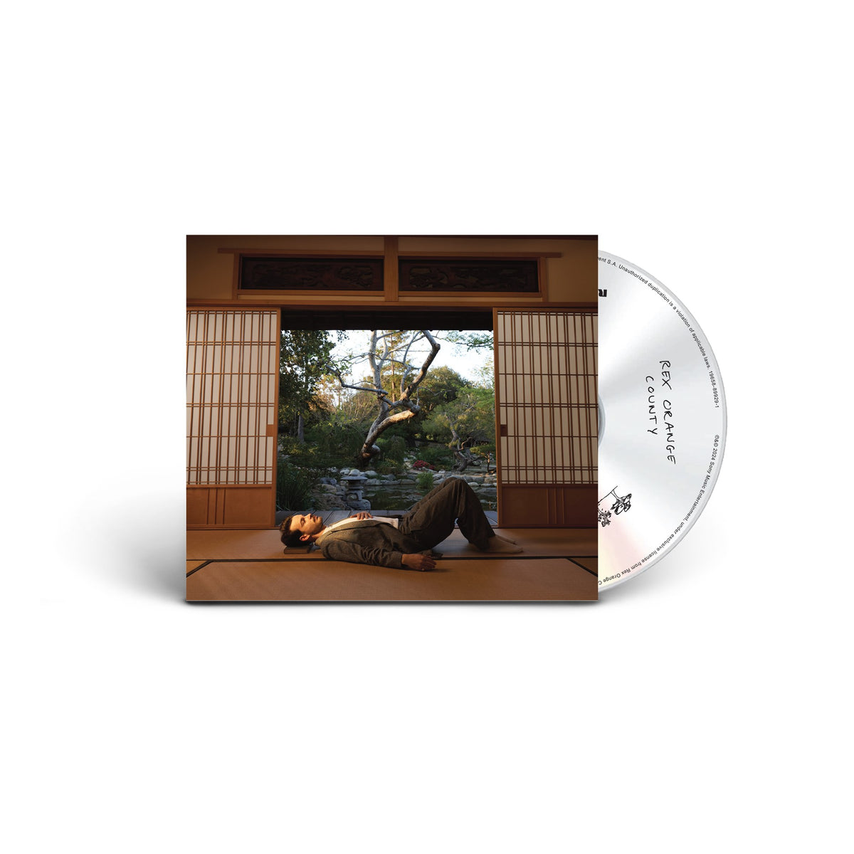CD cover for Rex Orange County’s “The Alexander Technique” with a man in a garden.