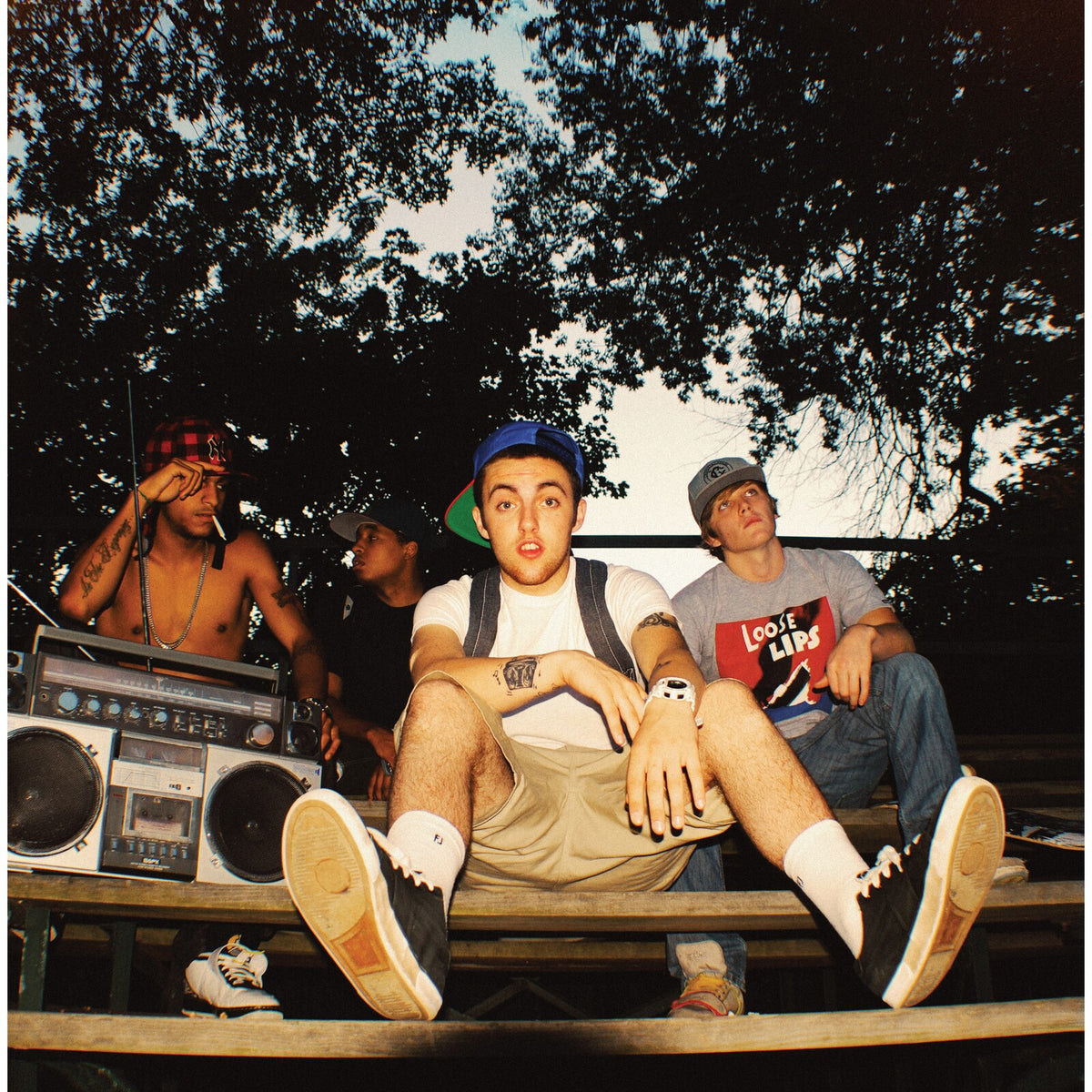 Mac Miller album cover, K.i.d.s., featuring a group of young men outdoors.