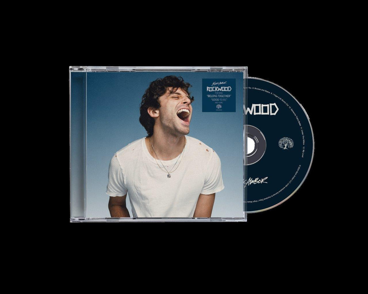CD case featuring Mark Ambor portrait against a blue and wood background.