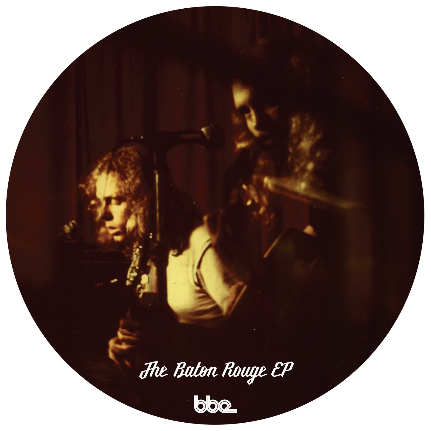 Vinyl record cover featuring two figures in a dimly lit, grainy photograph.