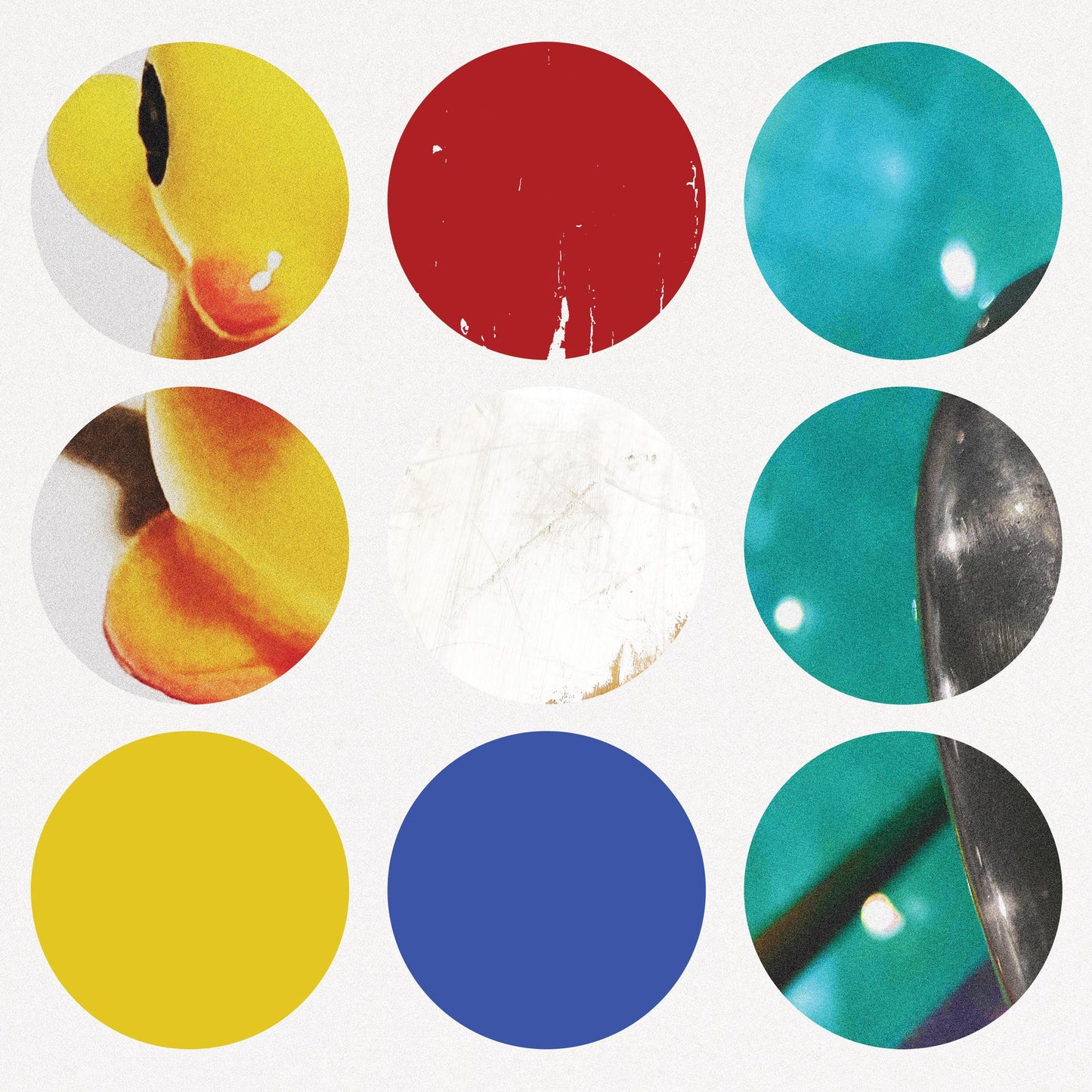 Album cover with colorful, overlapping circles and distorted facial features.