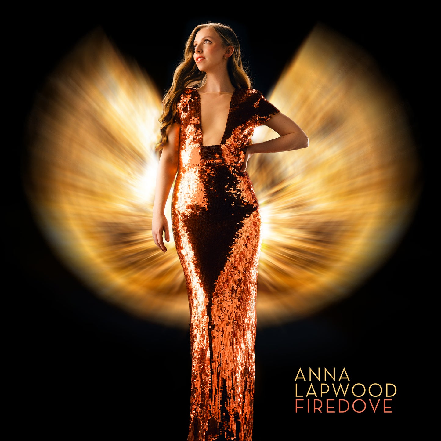 Anna Lapwood in a sequined copper gown against a glowing, wing-like light background.