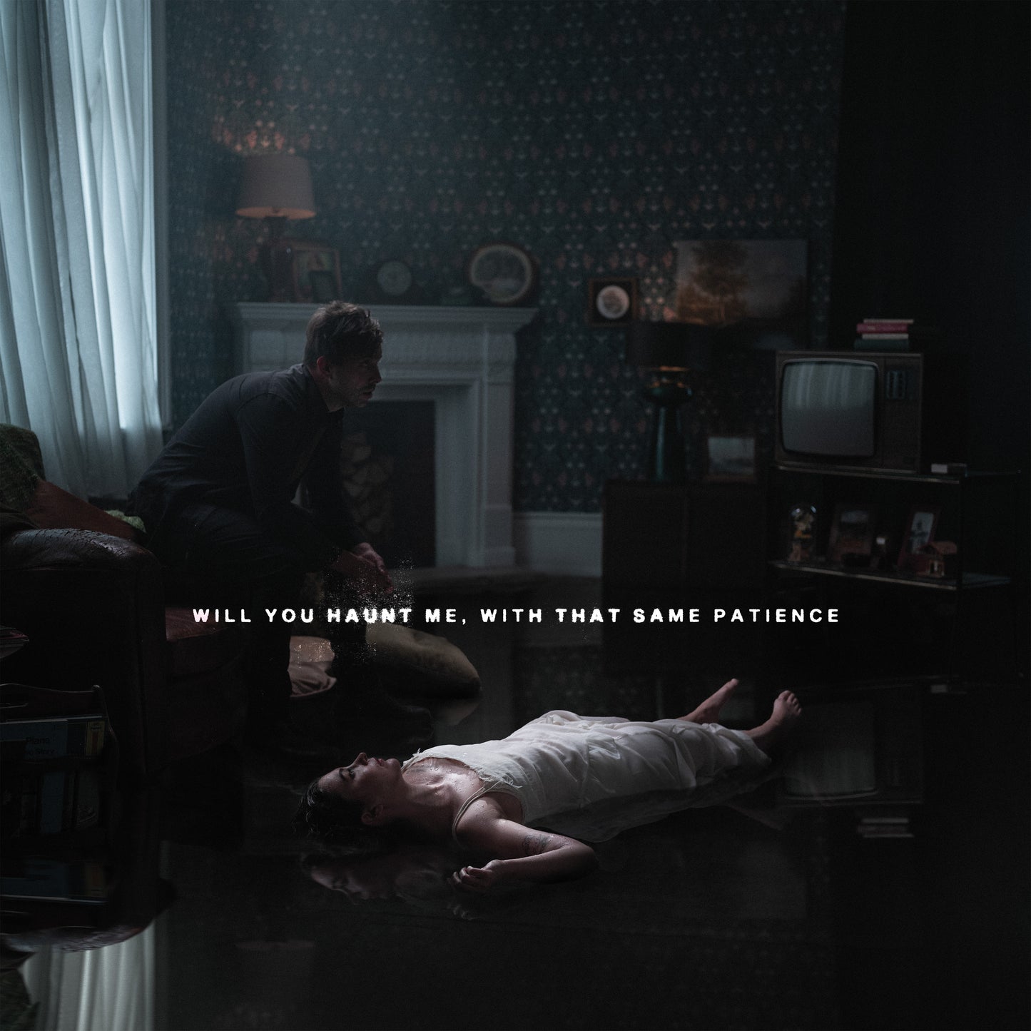 Dark album cover featuring a man and a person lying on a floor.