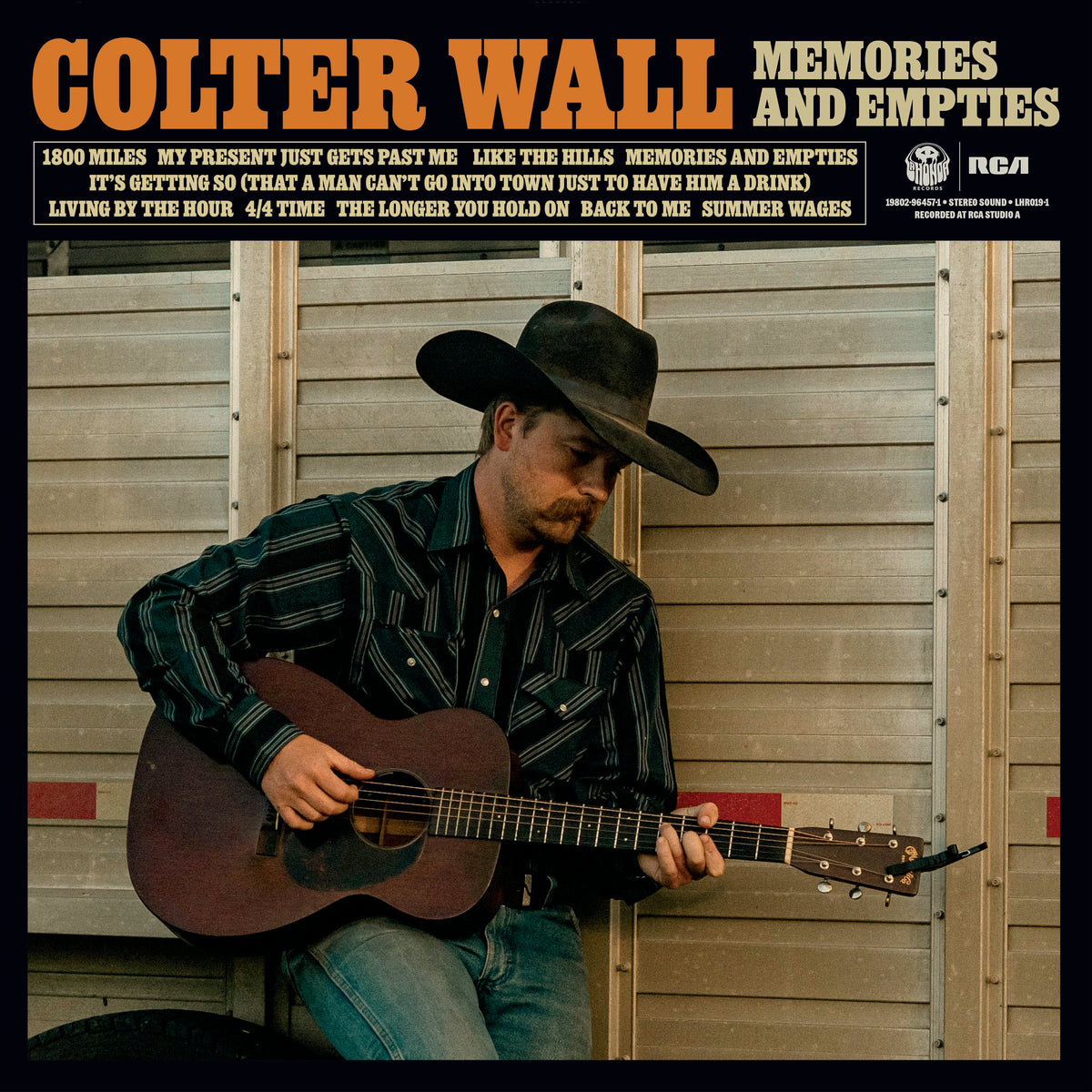 Colter Wall album cover: man with guitar in front of a barn.