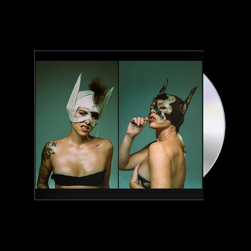 CD cover featuring two people with elaborate, pointed masks.