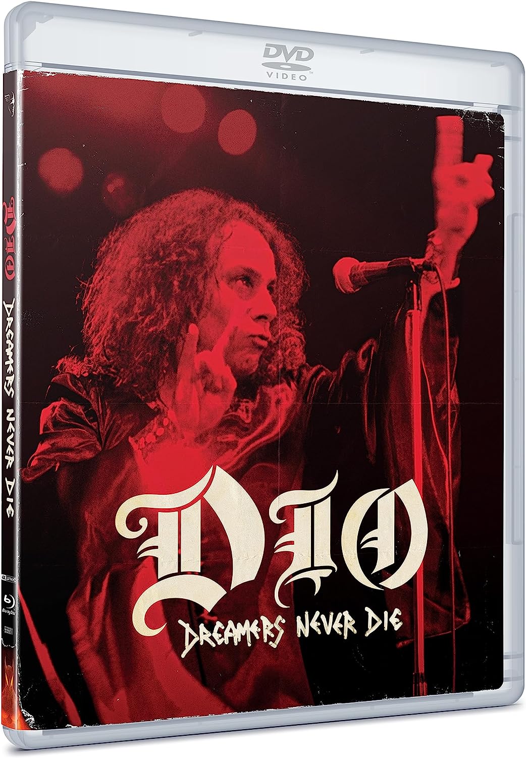 Ronnie James Dio performing on stage in a red-tinted DVD cover for Dreamers Never Die.