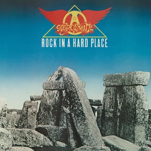 Aerosmith album cover: stonehenge with a winged logo and blue sky.