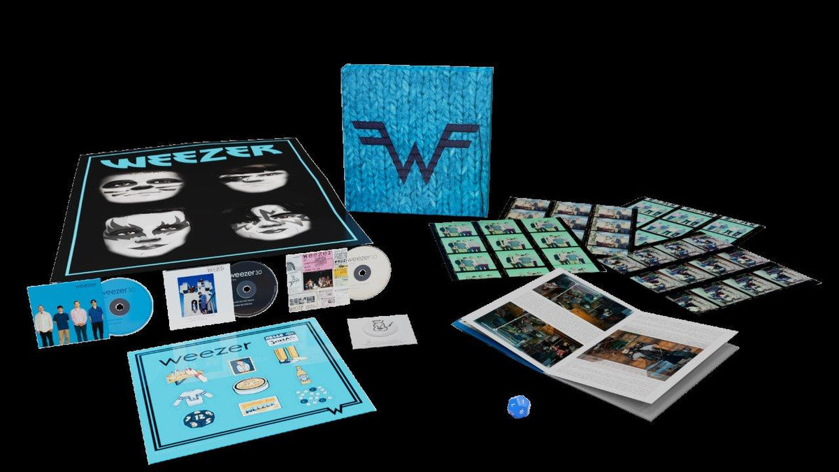 Weezer Blue Album 30th Anniversary CD set with packaging and memorabilia.