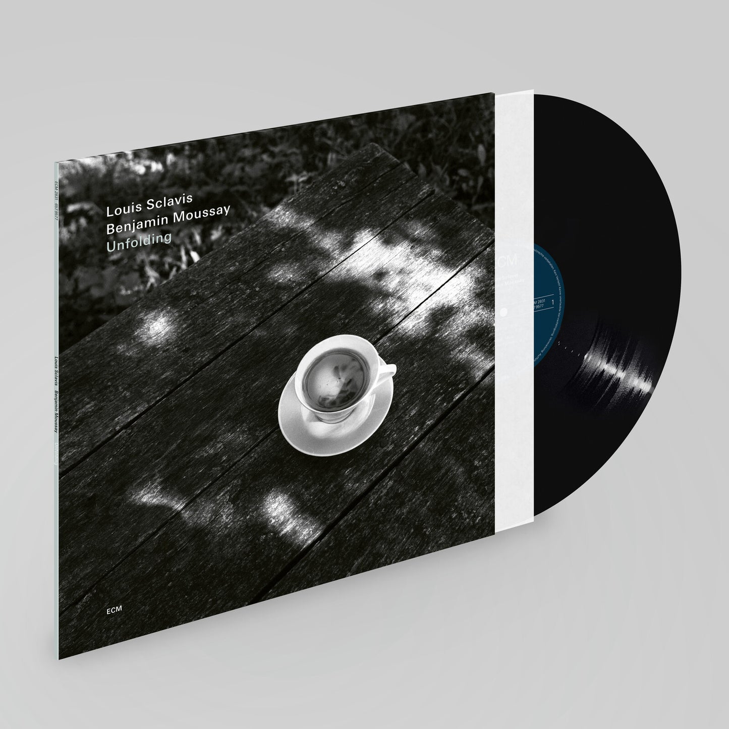 Vinyl record cover featuring a coffee cup on a textured surface.