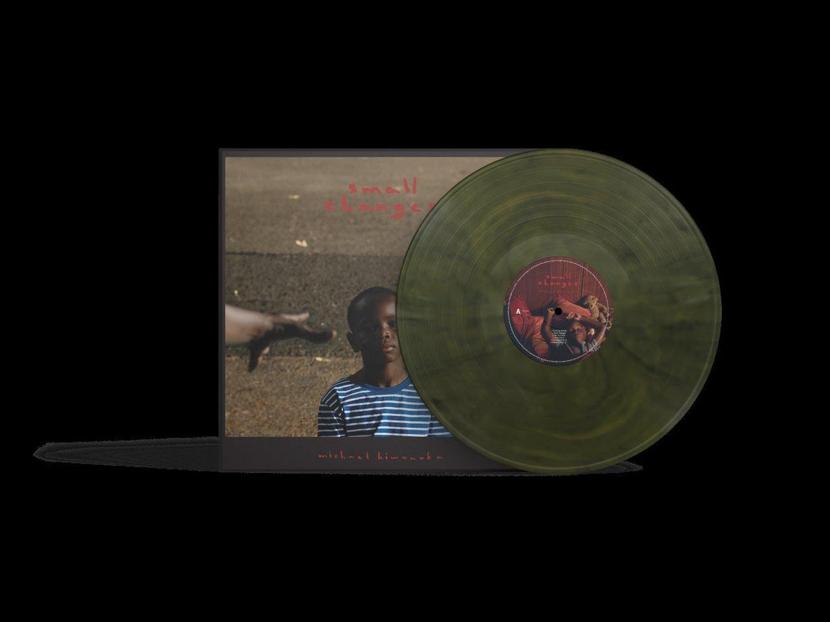 Green vinyl record of Michael Kiwanuka’s “Small Changes” with album cover visible.