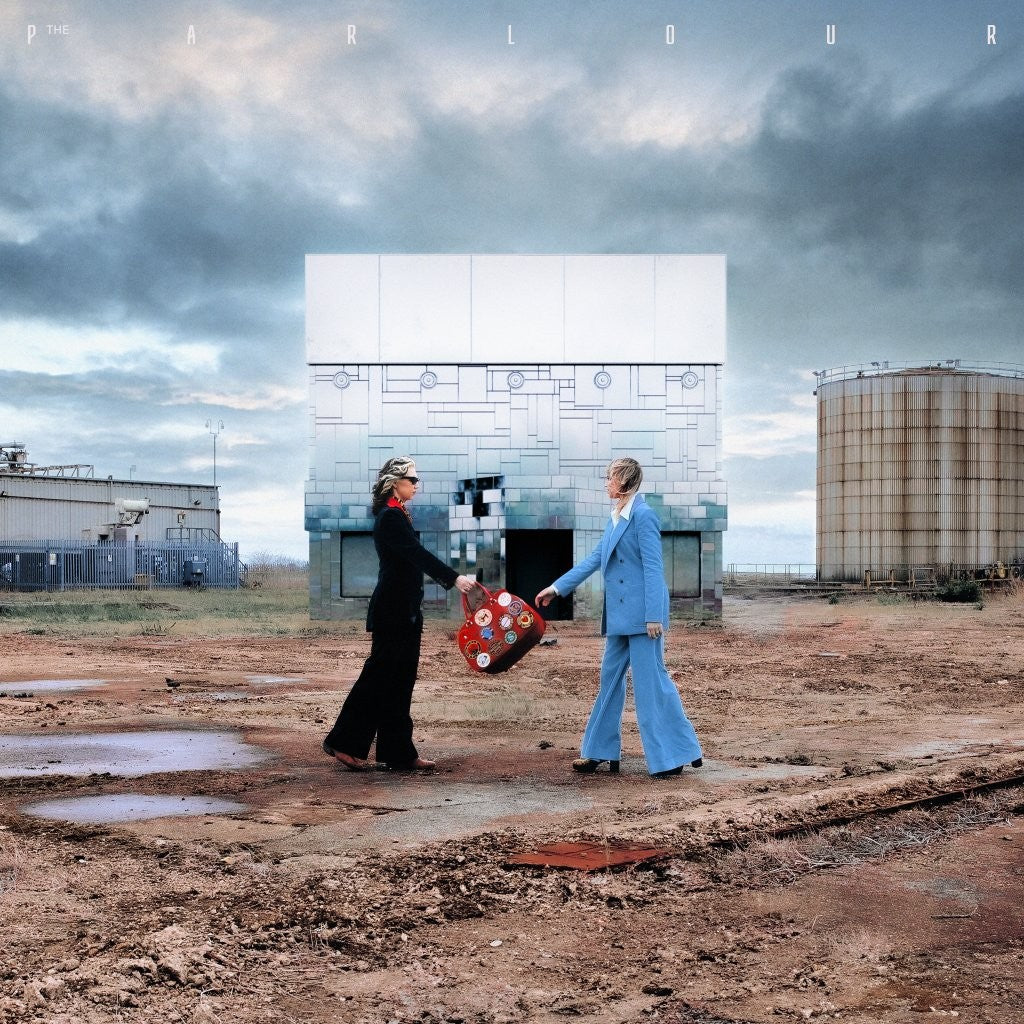 Album cover featuring two figures near an industrial landscape and drive-in screen.
