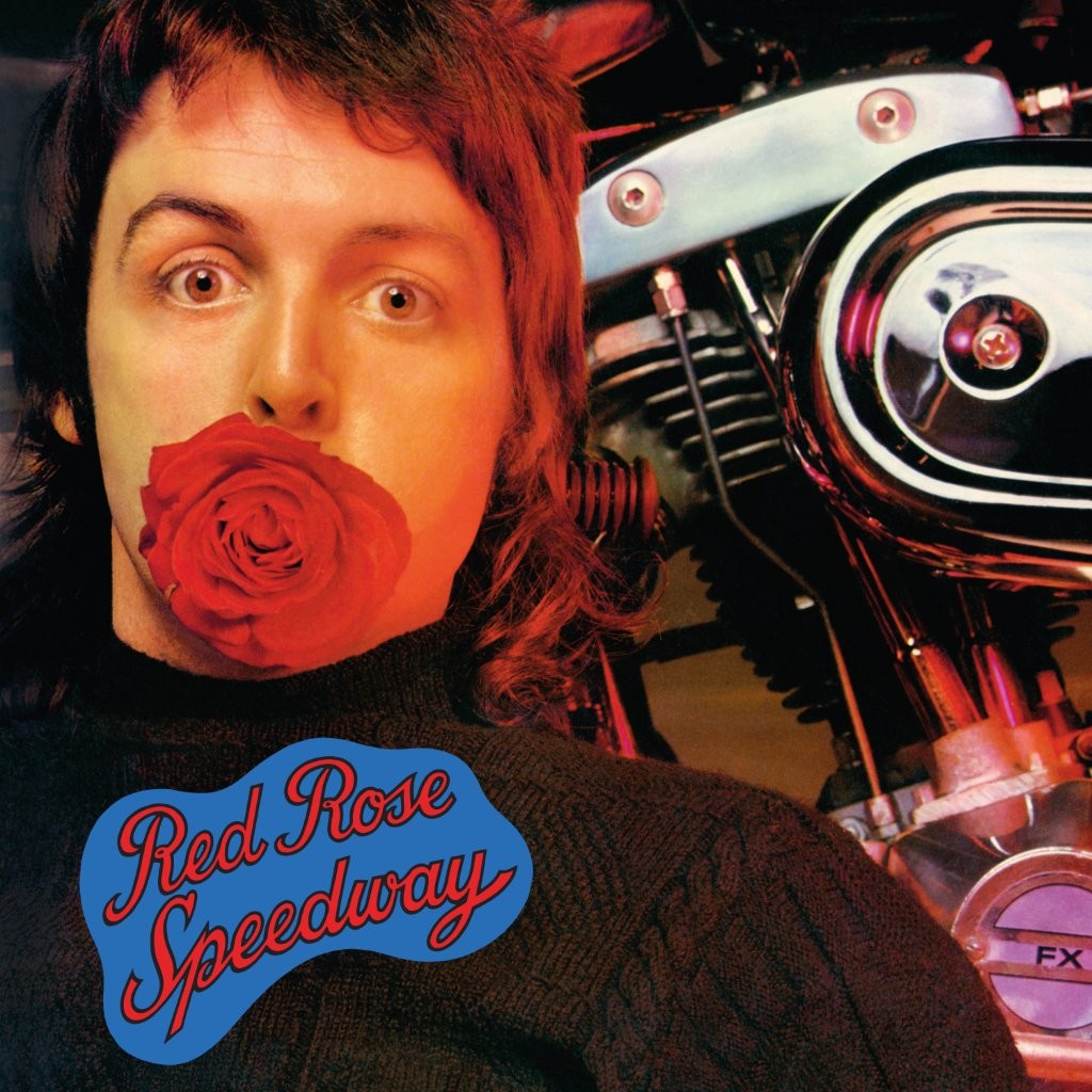 Paul McCartney with a red rose and a motorcycle, album cover.