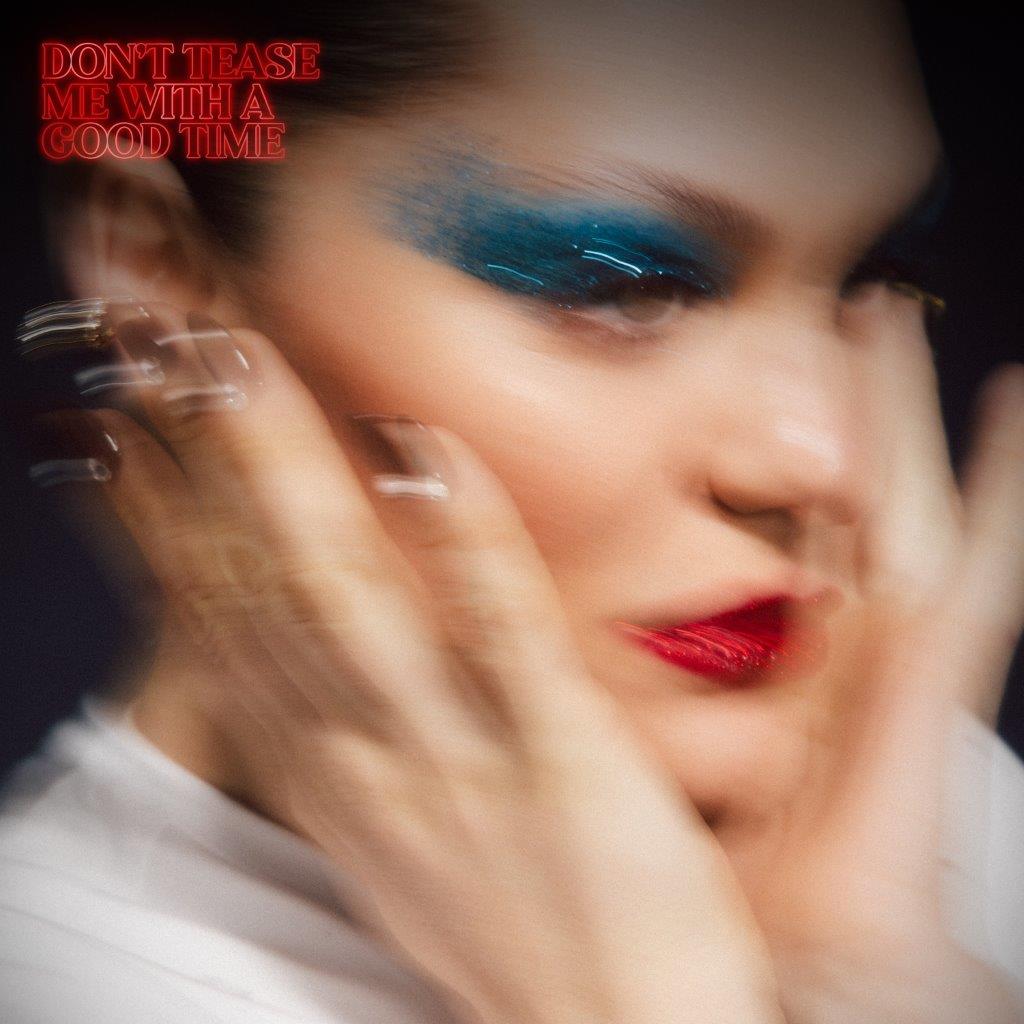 Jessie J album cover: close-up of a woman with red lips and blue eyeshadow.