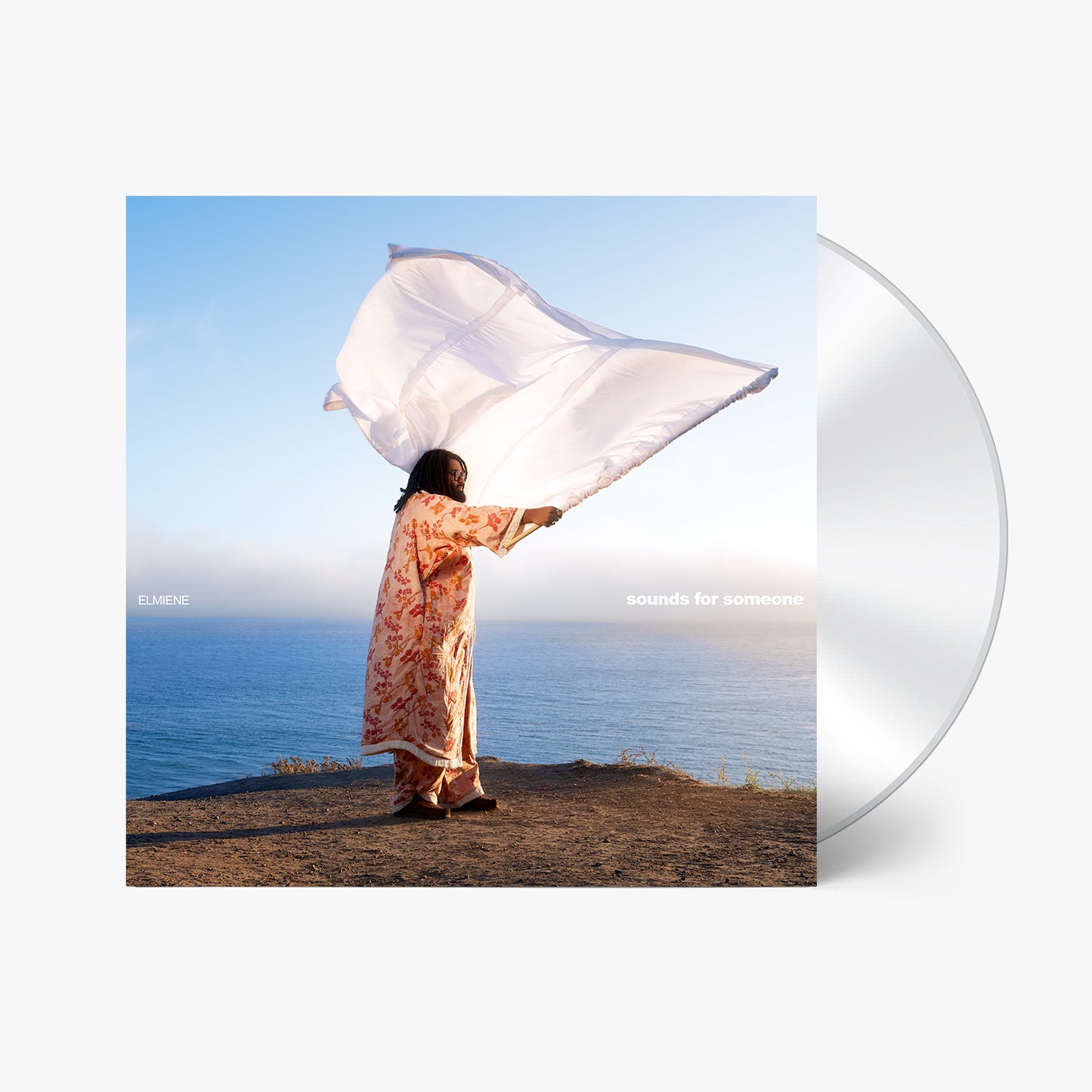 CD cover: woman with flowing fabric overlooking the ocean.