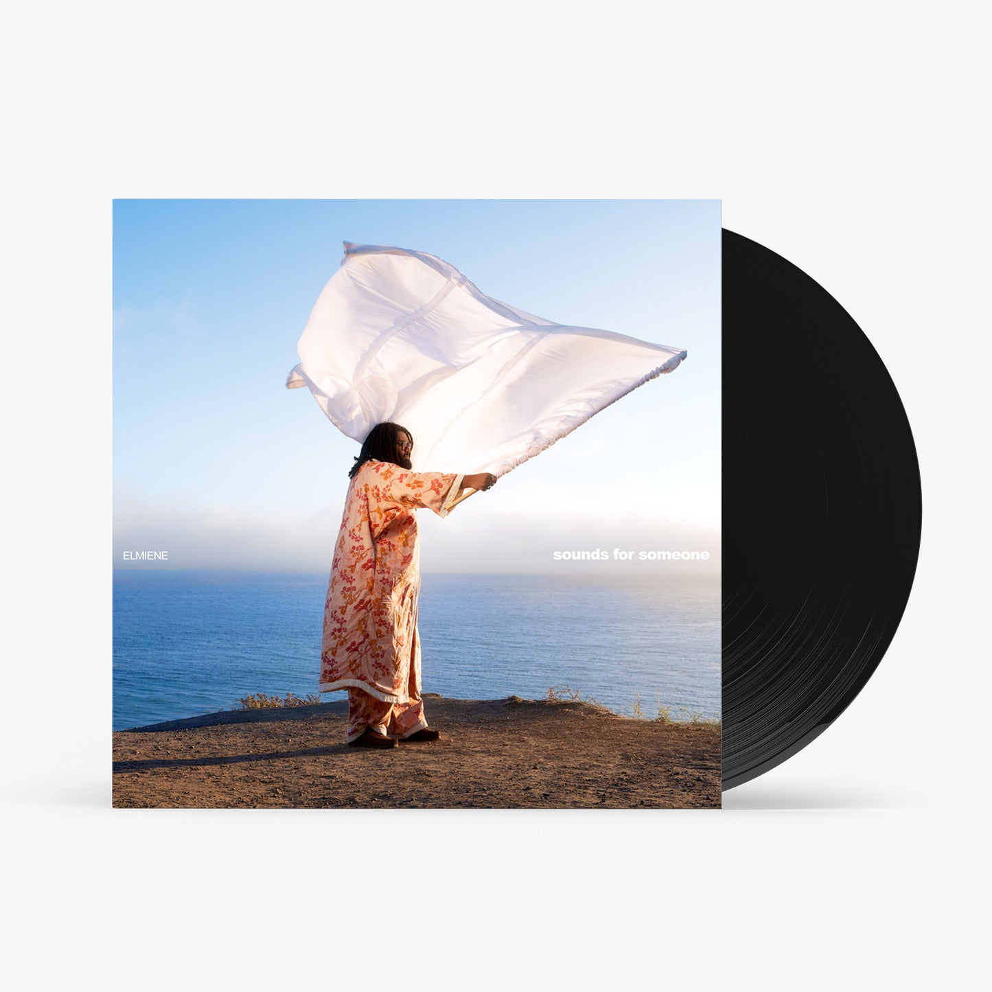 Vinyl record and album cover featuring a person with a flowing fabric.
