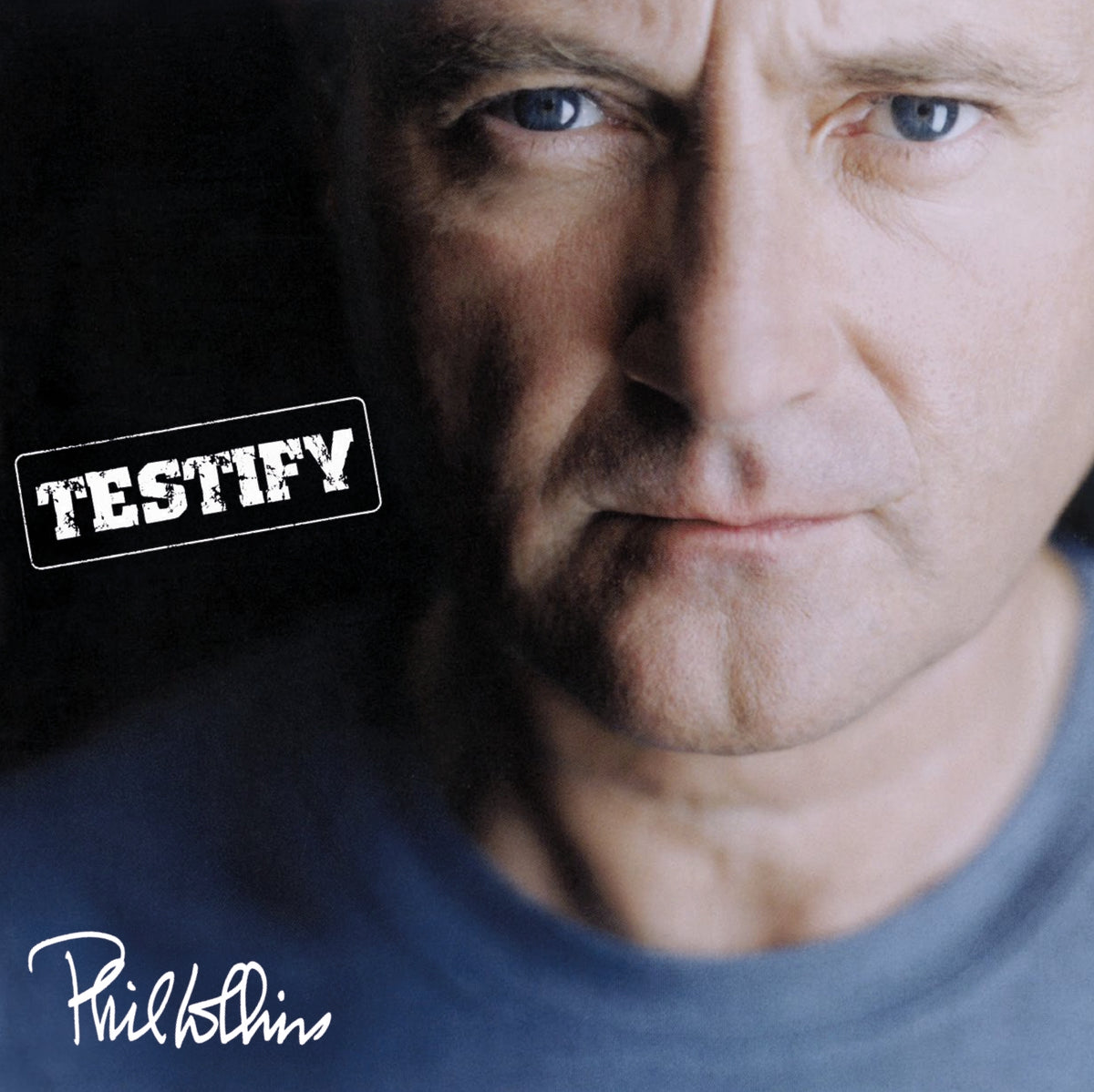 Close-up portrait of Phil Collins, album cover for "Testify.