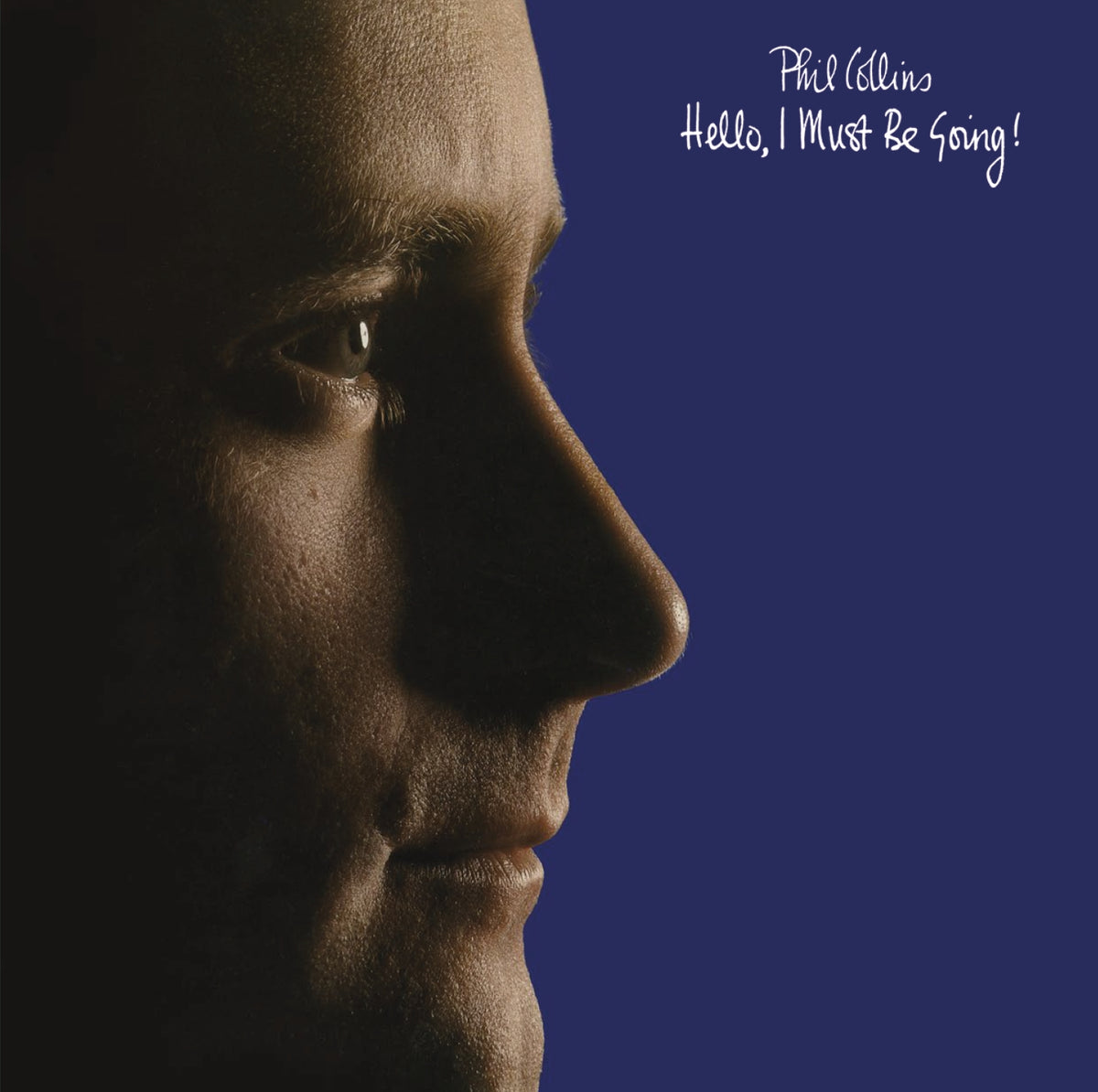 Phil Collins album cover: profile of a man on dark blue background.