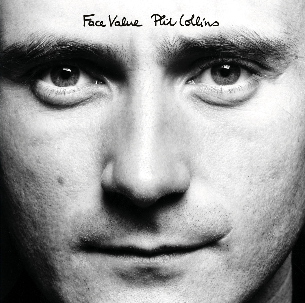 Black and white close-up portrait of Phil Collins for the album "Face Value".