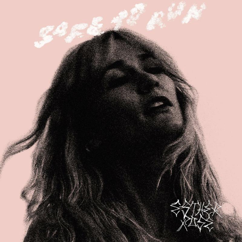 Black and white portrait of a woman with long hair, album cover.