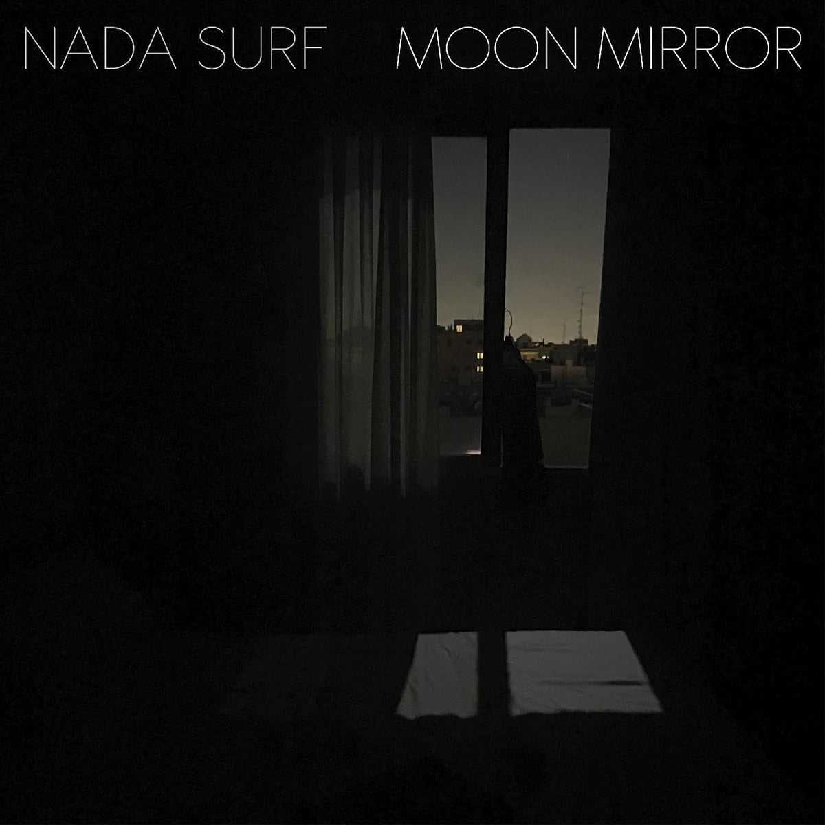 Dark album cover with a window view and the text "NADA SURF MOON MIRROR".