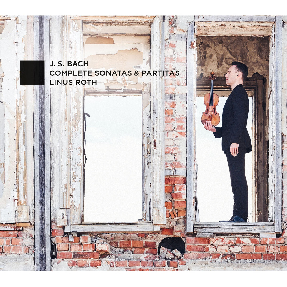 Violinist Linus Roth stands in a decaying brick doorway, album cover.