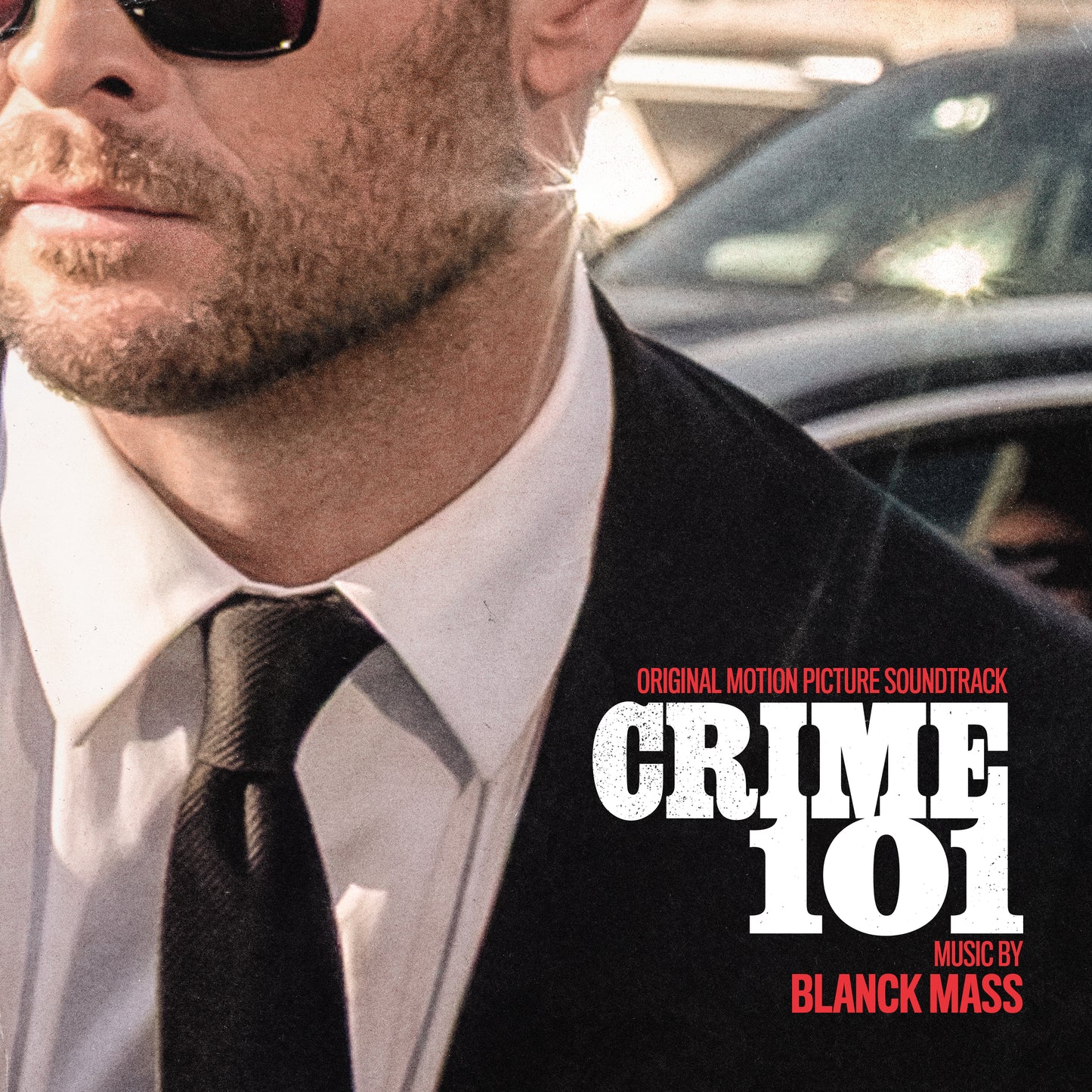 AlbumLCLose-up of a man in a suit and sunglasses for Crime 101 soundtrack.