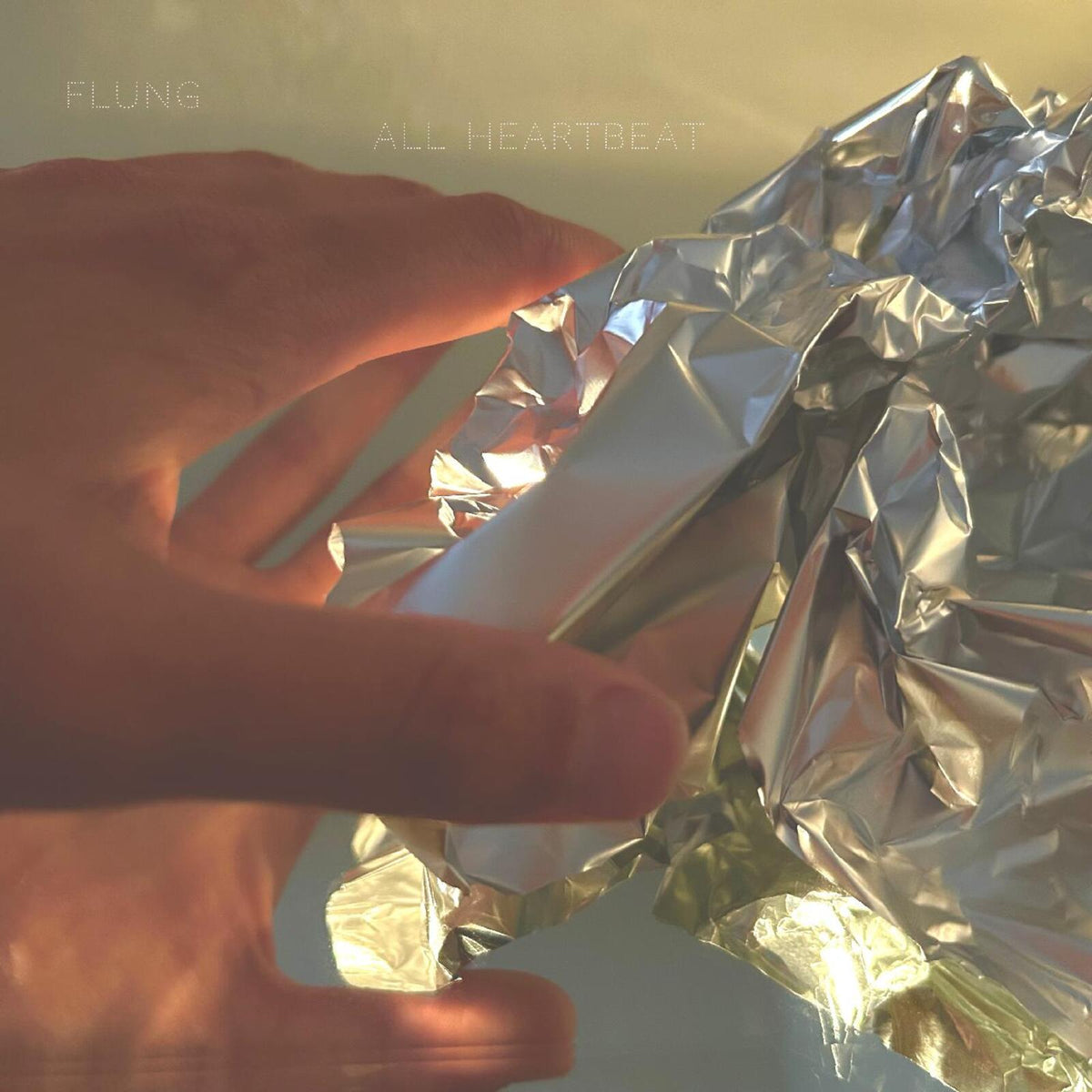 Album cover for Flung’s “All Heartbeat” featuring crumpled silver foil.