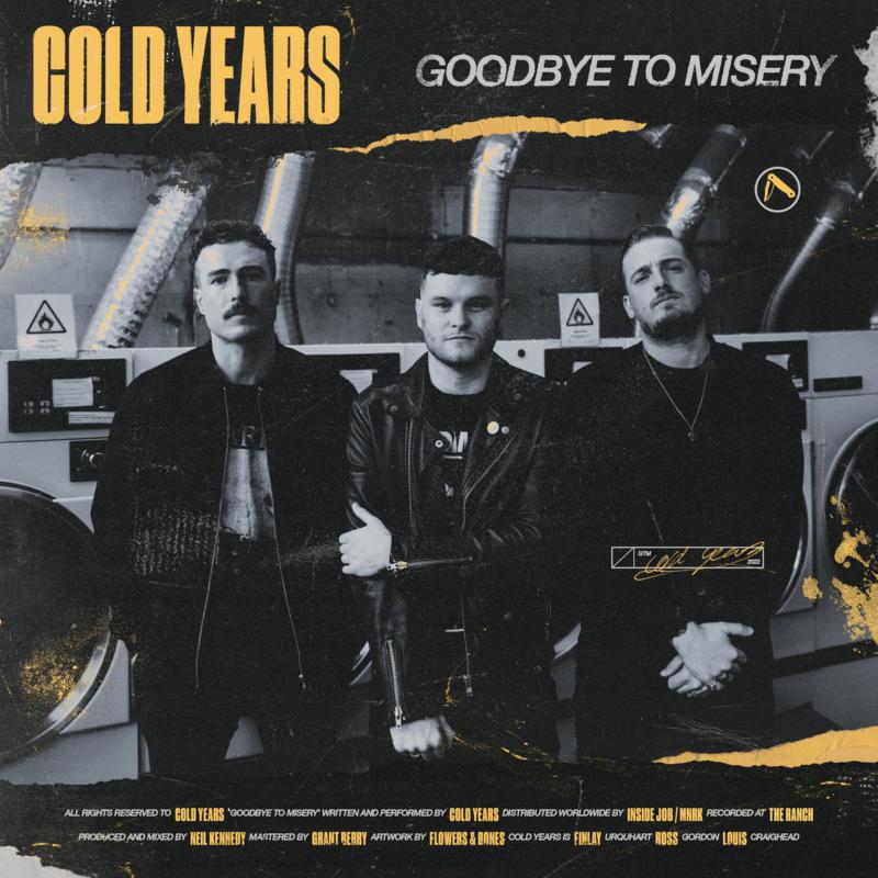 Three men stand in front of washing machines, album cover art.