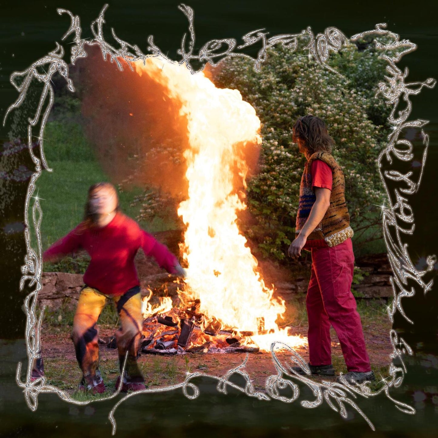 Album cover with two figures near a large, bright bonfire.