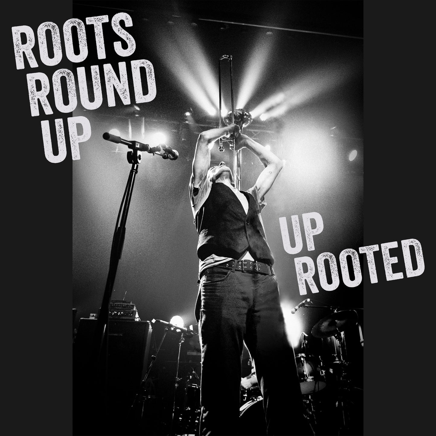 Black and white concert photo of a singer with raised arms.
