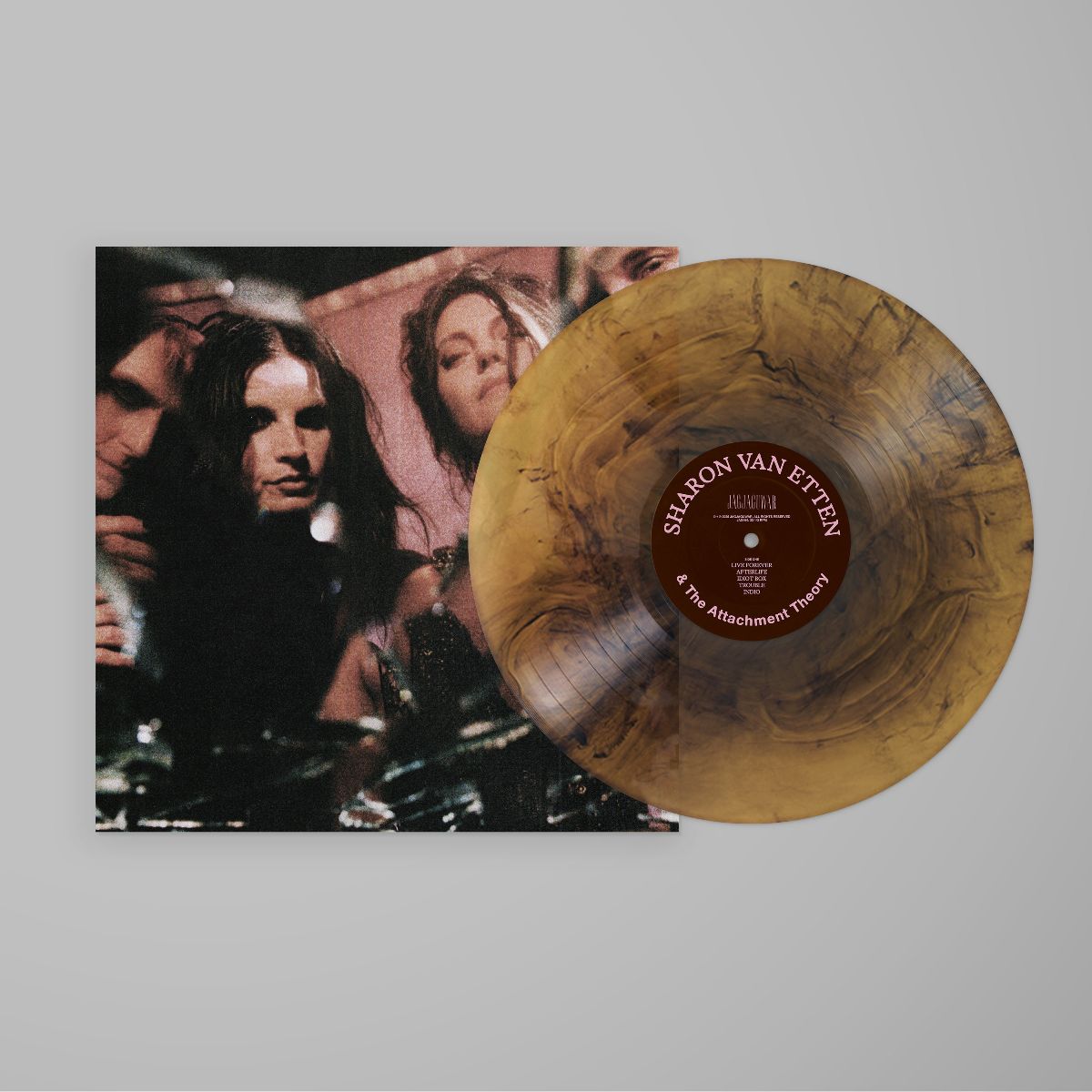 Amber vinyl record with album artwork featuring three faces.
