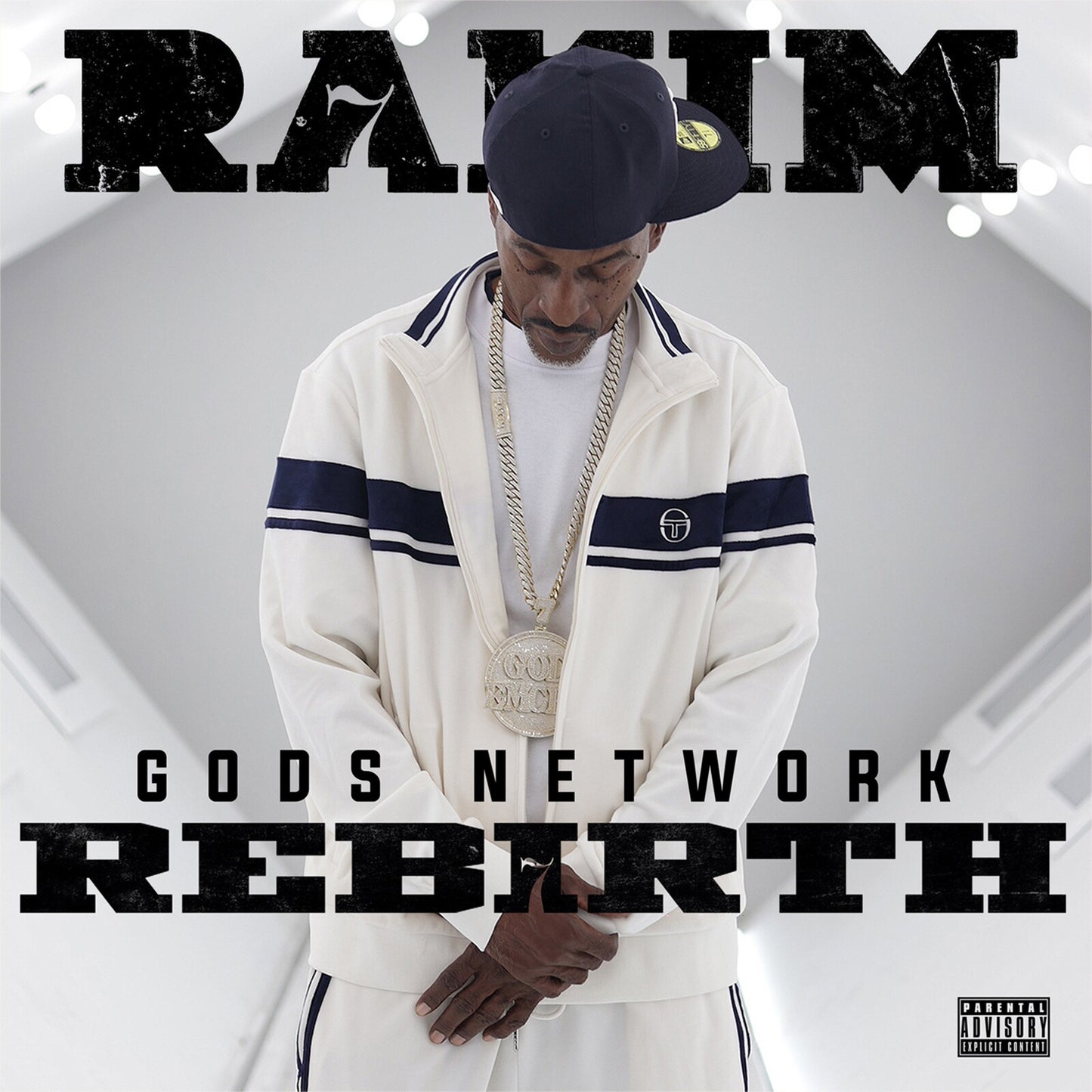 Rakim wearing a white tracksuit and large chain against a bright, minimalist background.