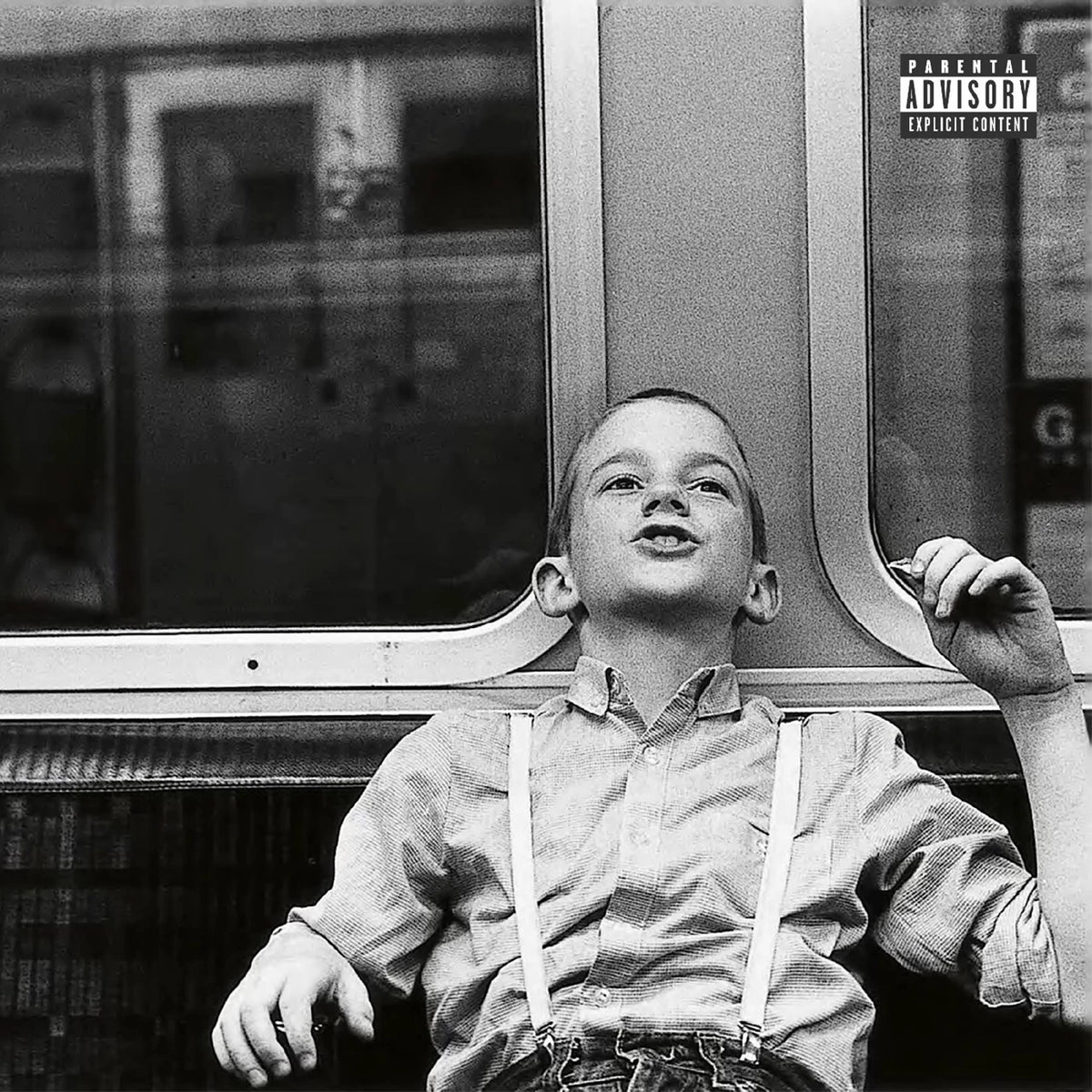 Black and white album cover featuring a young boy looking upwards.