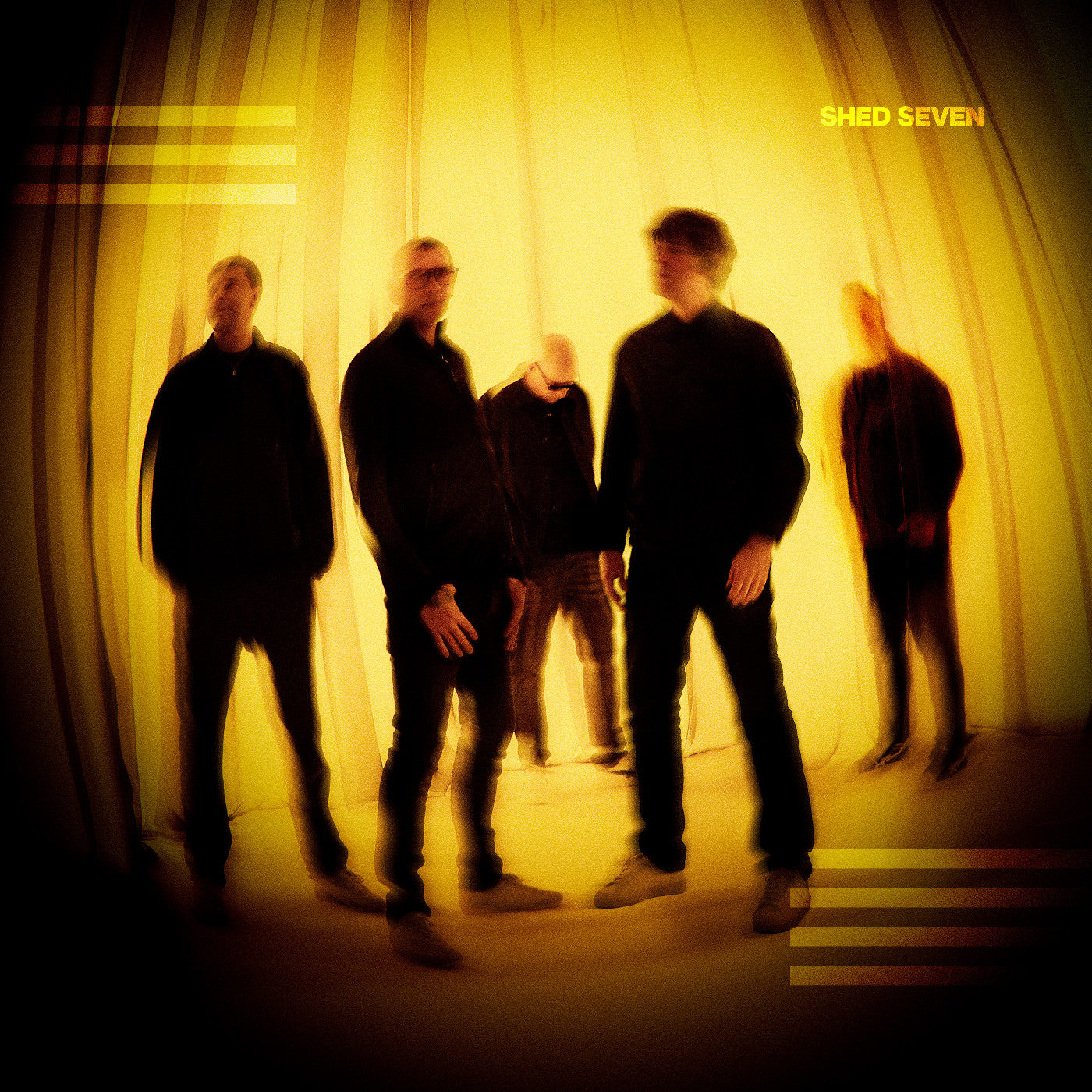 Blurred image of band Shed Seven against a yellow, draped background.