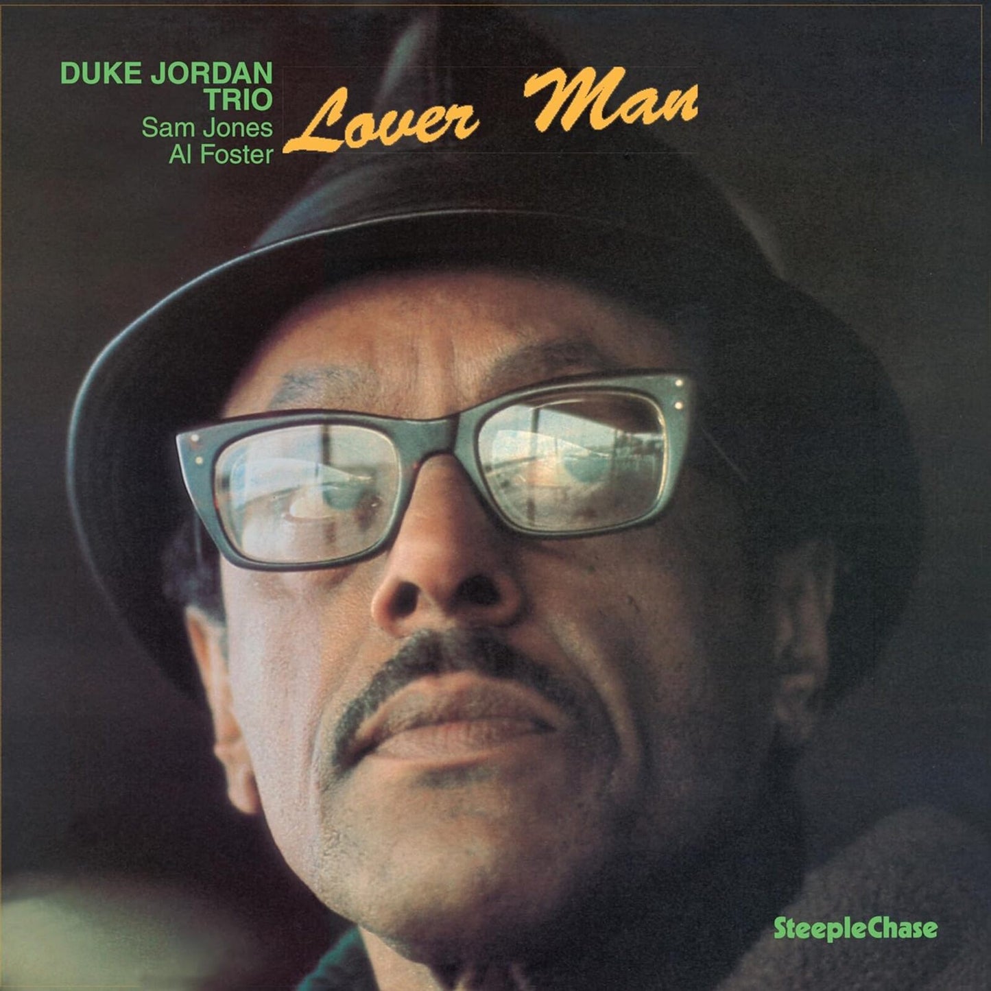 Close-up of Duke Jordan wearing sunglasses and a hat, album cover.