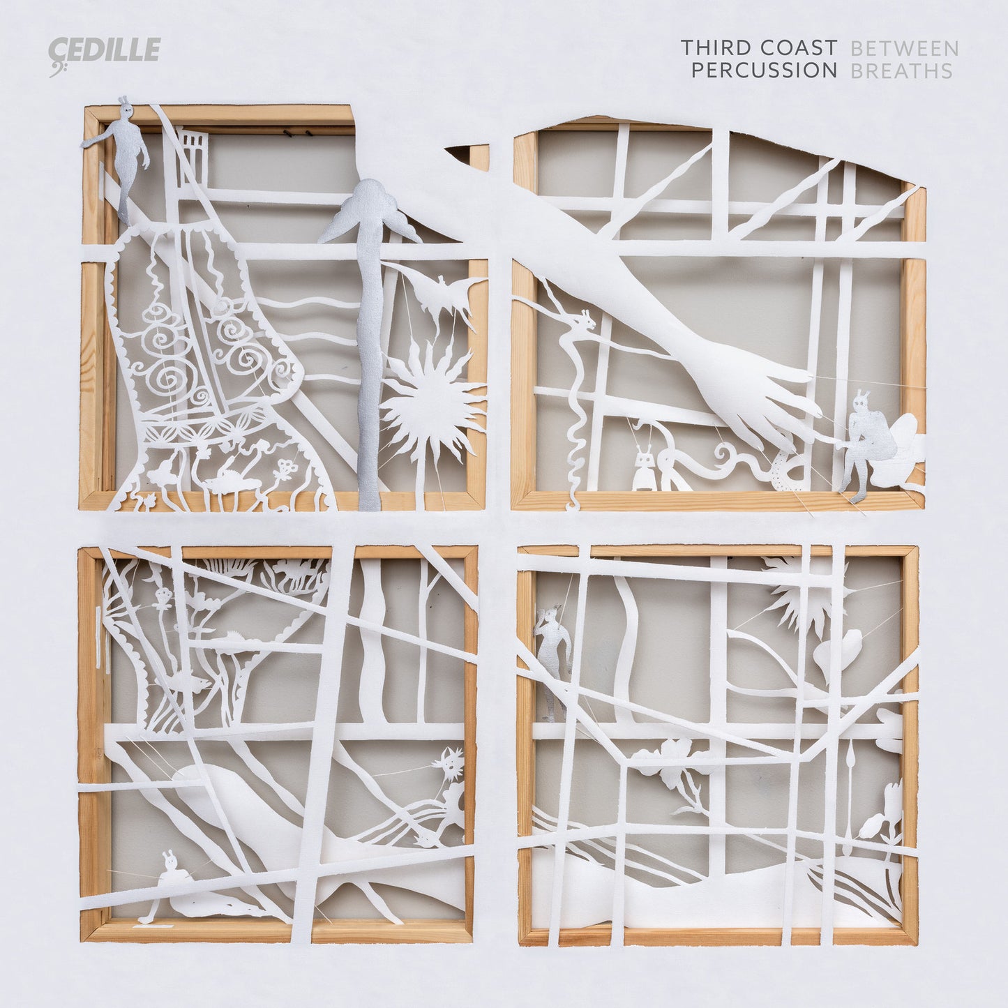 CD cover with four panels depicting paper-cut figures and abstract designs.