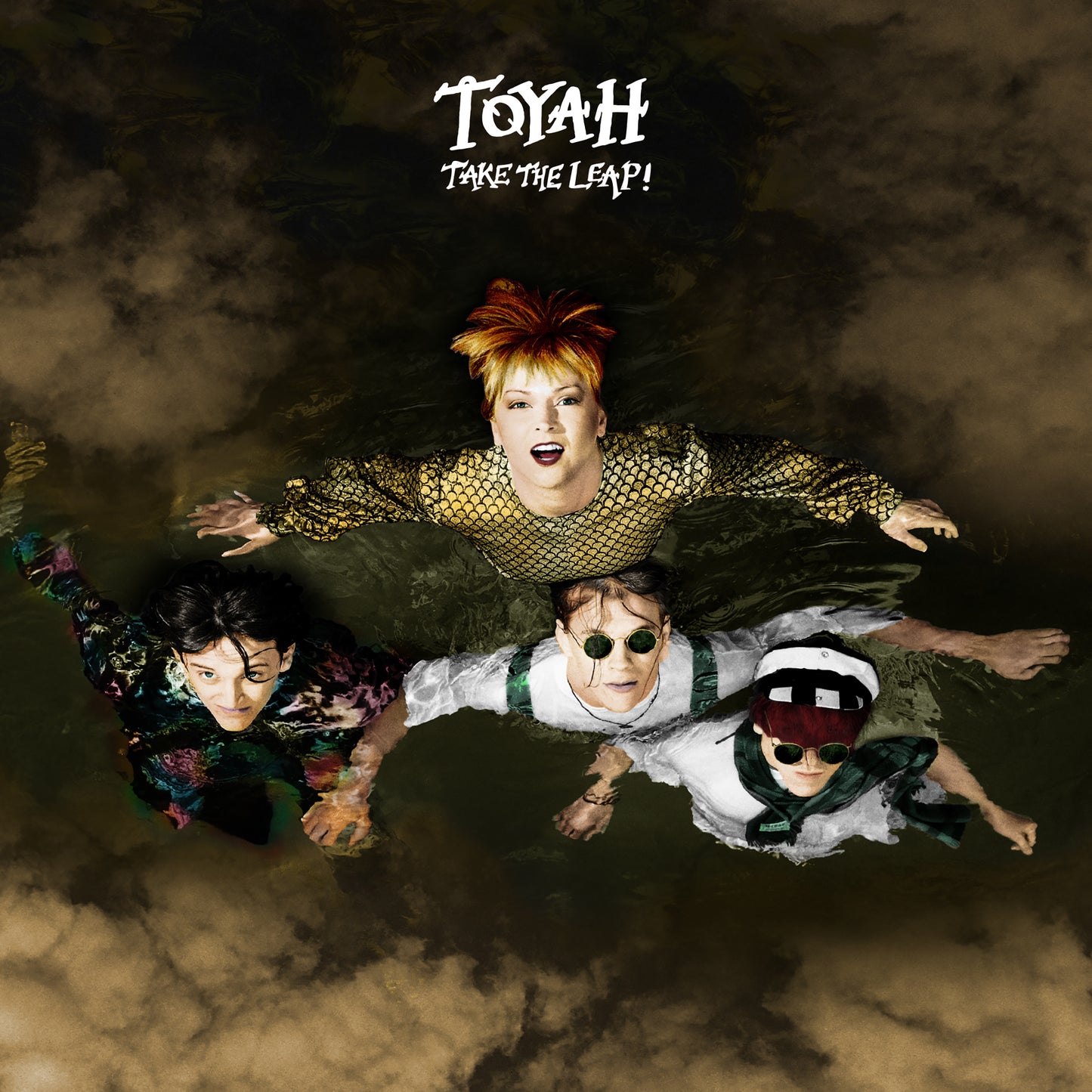 Toyah and three other people floating in dark water, viewed from directly above.