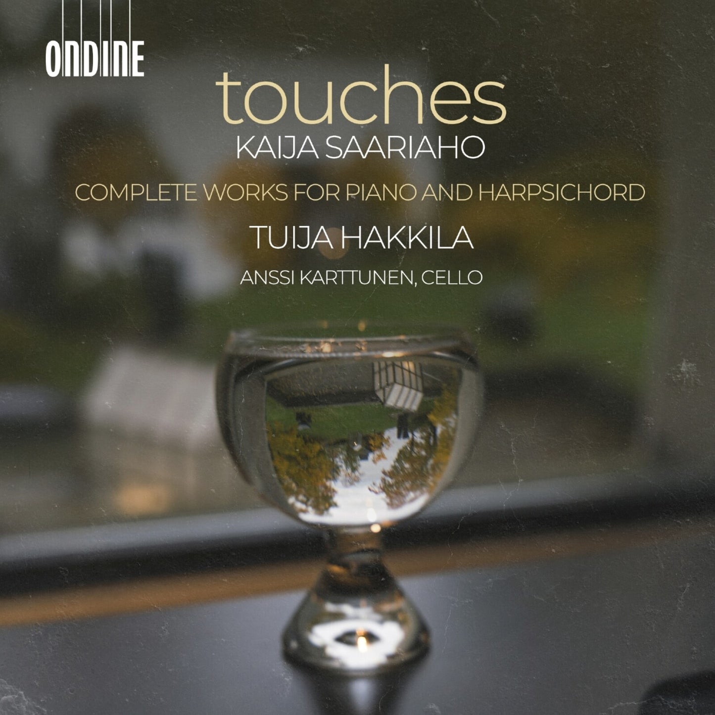 CD cover for "Touches" by Saariaho, featuring a mirrored glass orb.