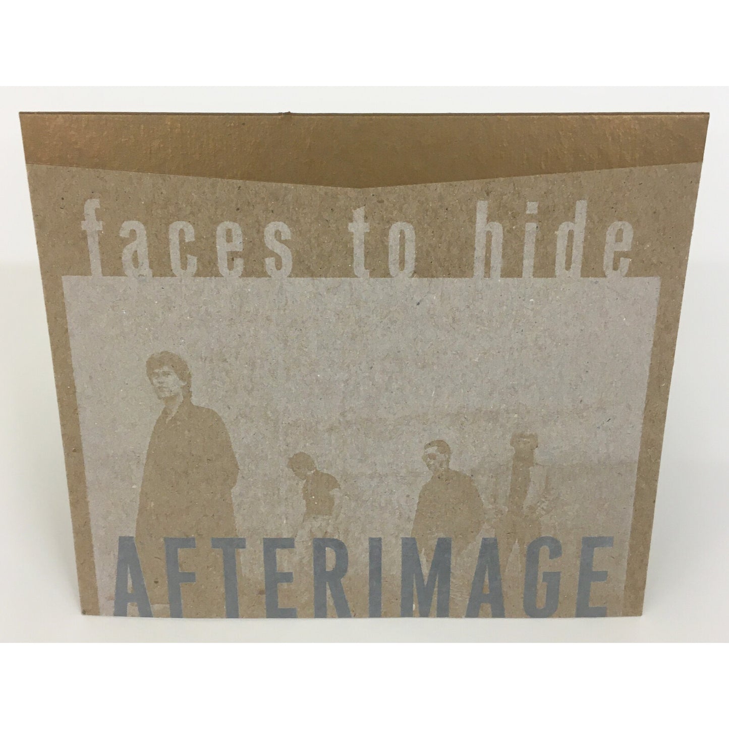 Cardboard CD sleeve with the text faces to hide and AFTERIMAGE over four silhouettes.