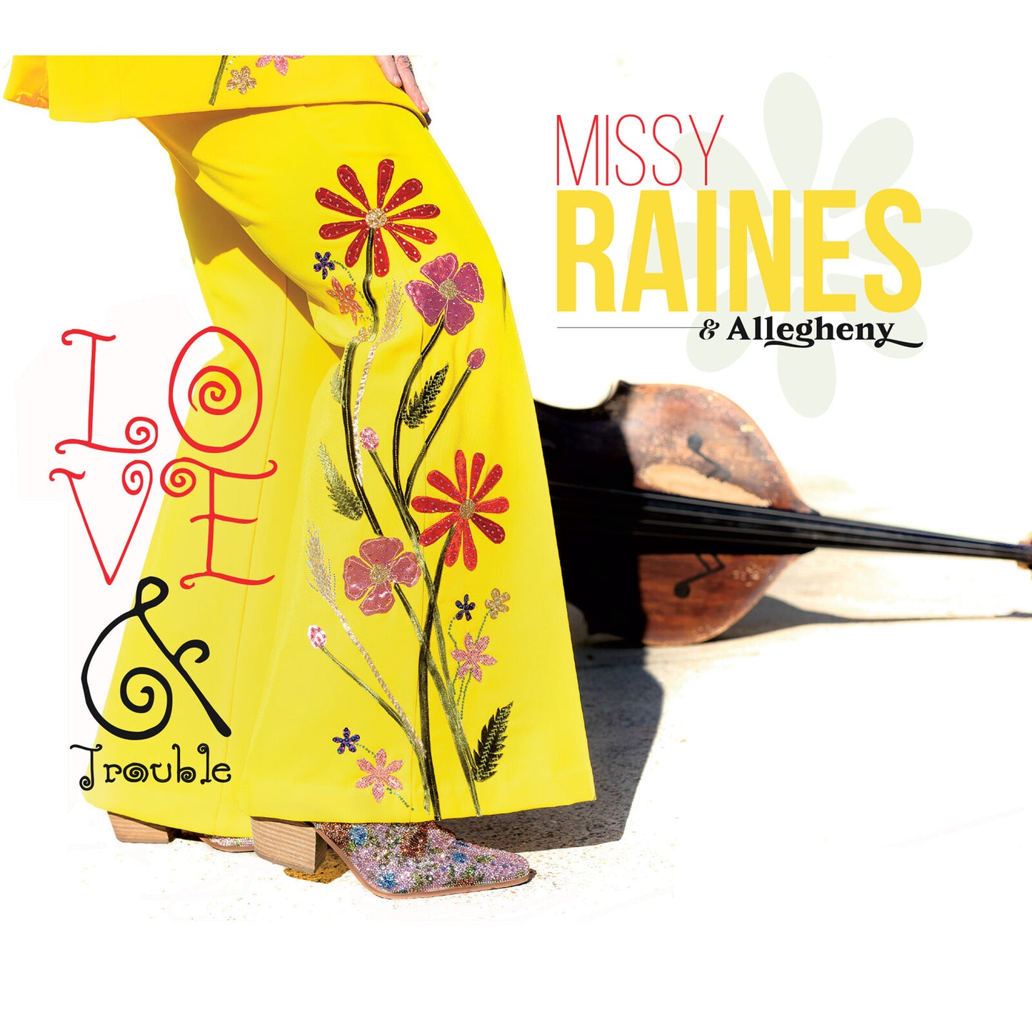 CD cover: woman in yellow suit with floral embroidery, text “Love & Trouble”.