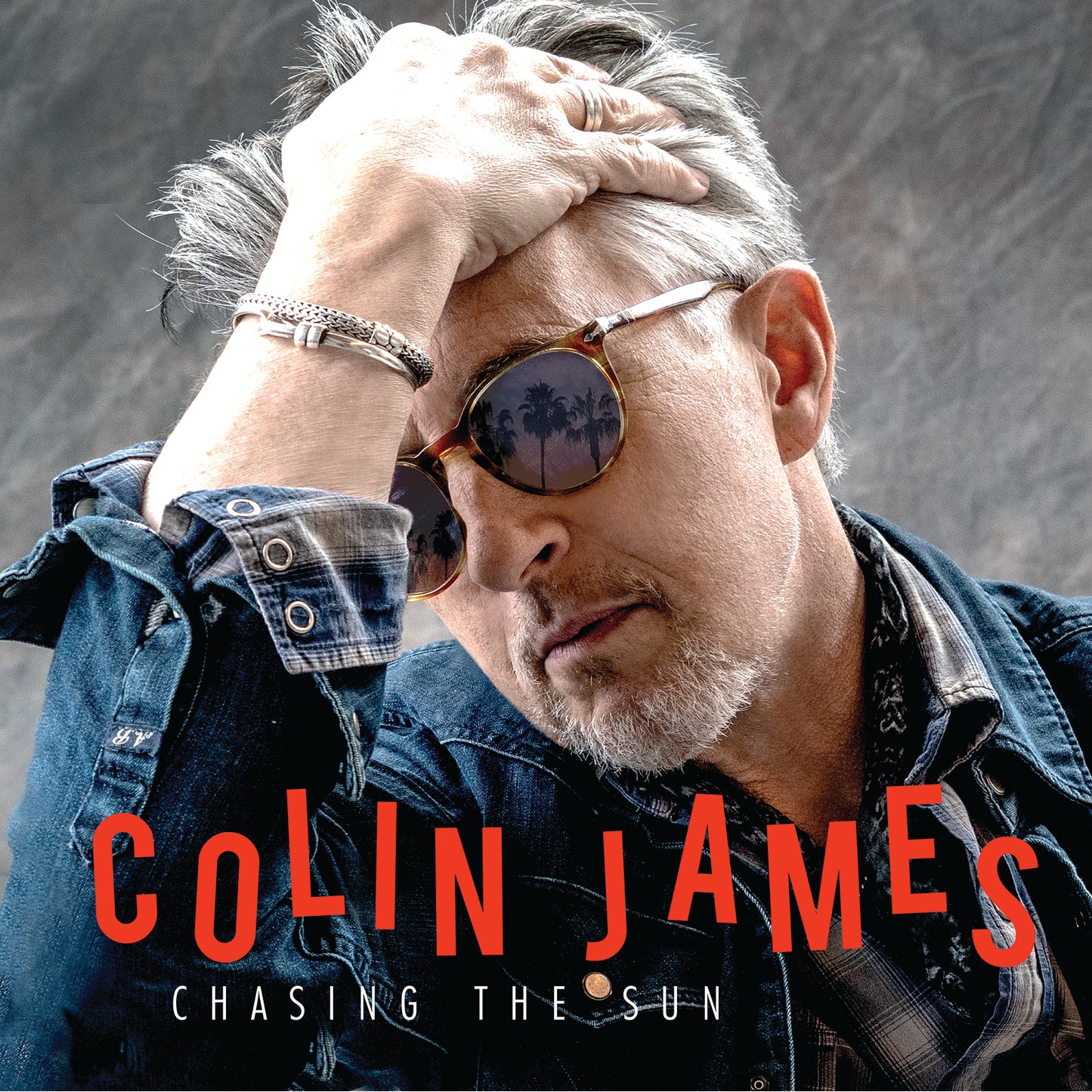 CD cover featuring musician Colin James in sunglasses, with a sunset reflection.
