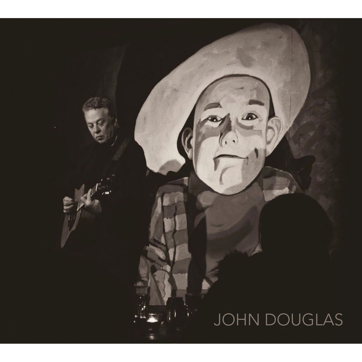 Black and white album cover featuring a painted portrait and guitarist.