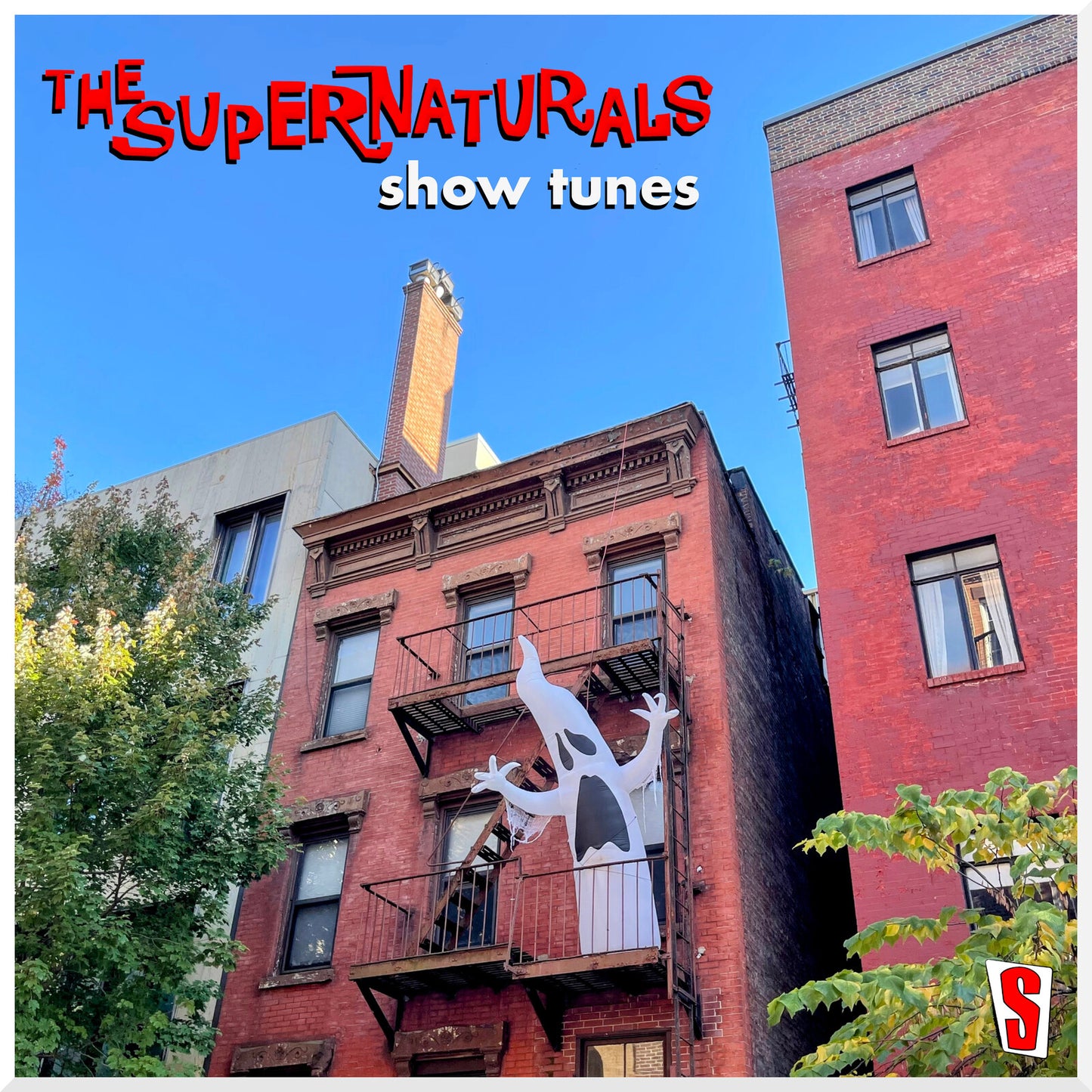 CD cover: red brick building with a ghost image and text.