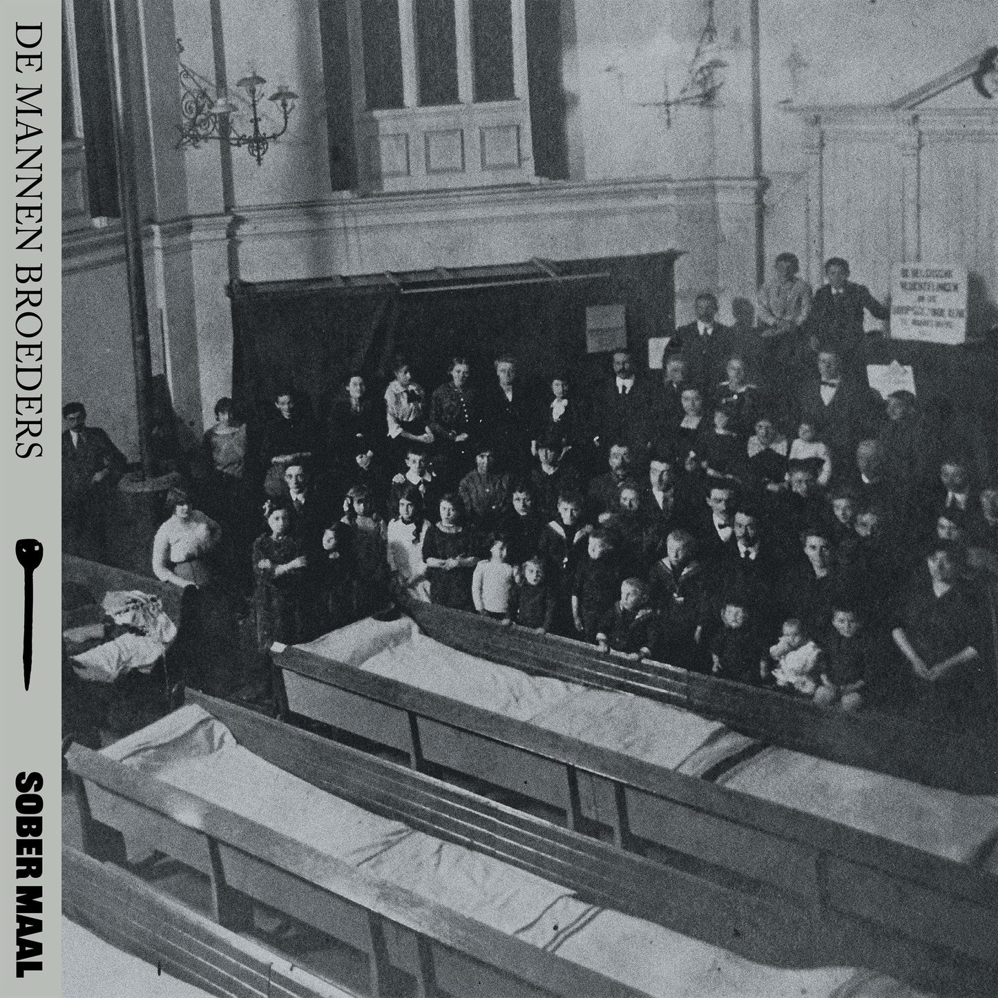 Black and white album cover depicting a group seated before coffins.